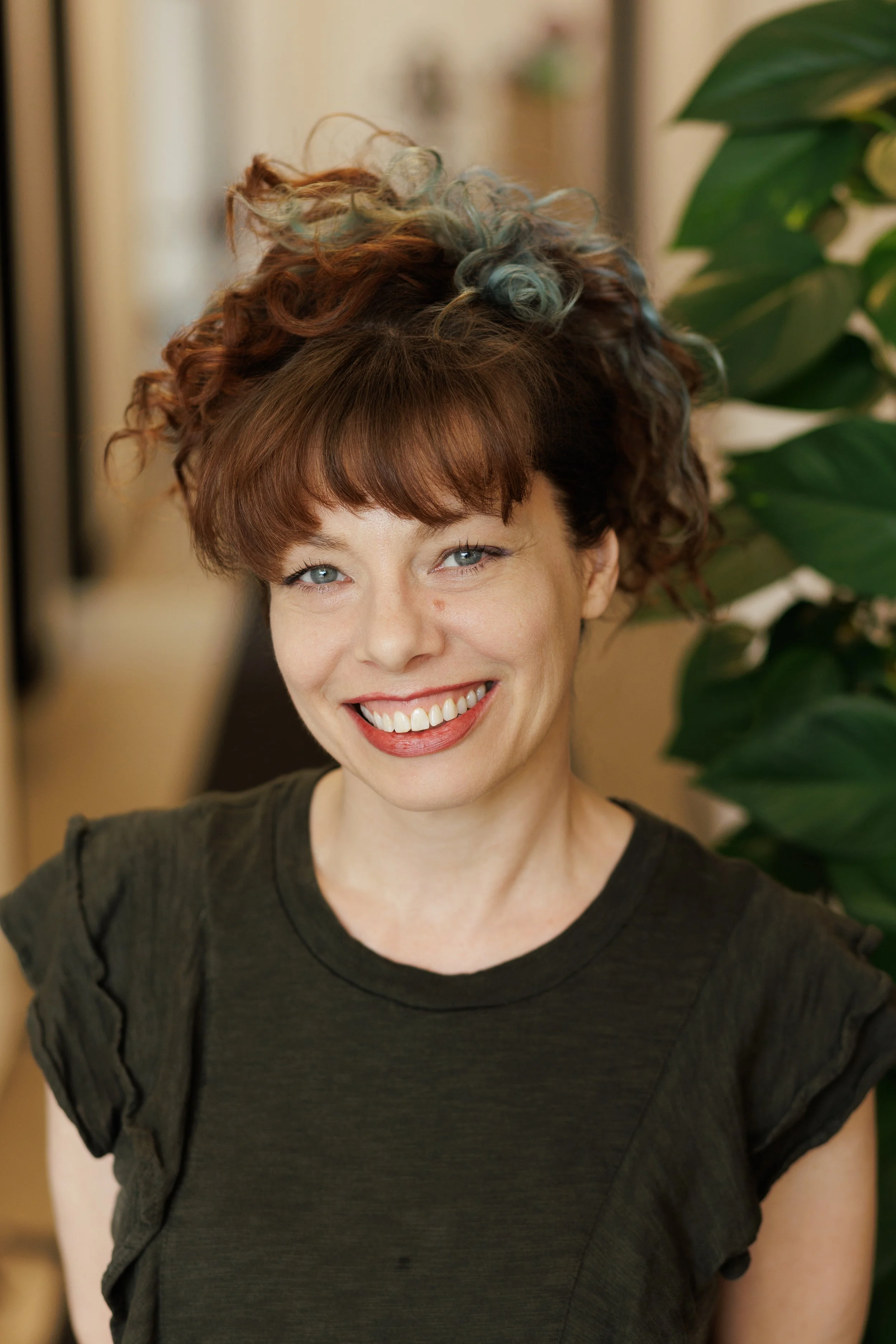 Woman with short dark hair smiling