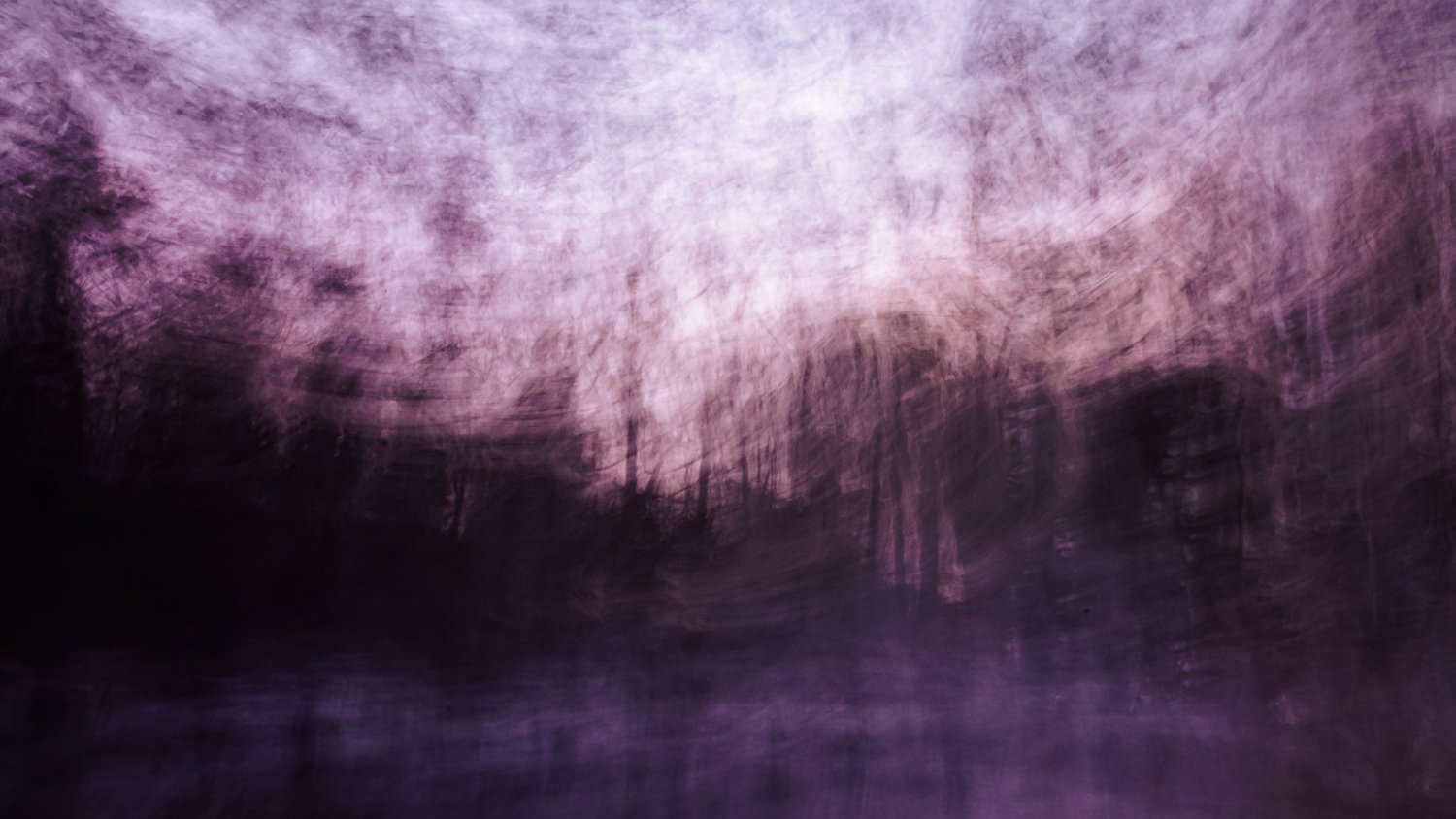 Abstract purple and black blurred landscape with trees and a body of water