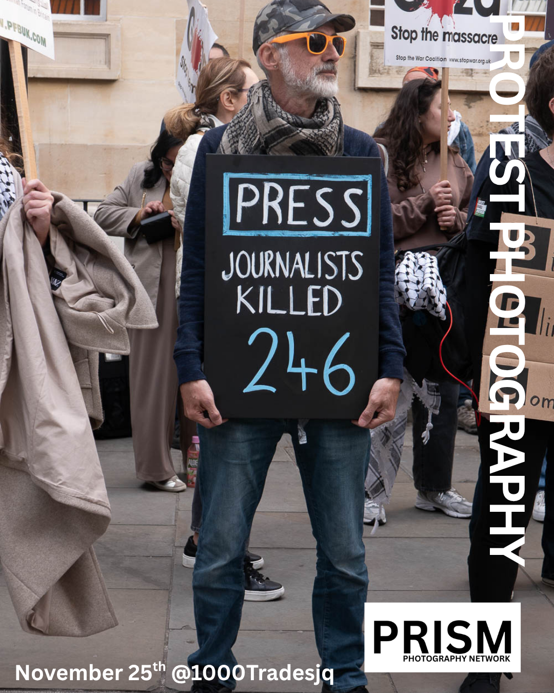 An image of a man with a placard hanging from his neck which reads 246 journalists killed. He is looking to his left - not engaging with the camera.