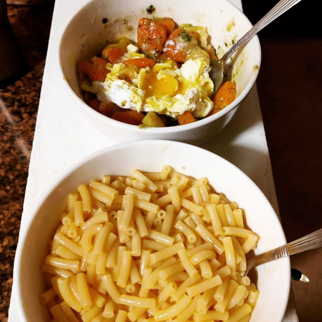 Our &quot;fend for yourself&quot; supper this evening, which took both of us a total of 15 minutes.  My bowl (on the top) is holiday shaped gnocchi with a homemade pesto and a poached egg. Caleb's is a box of store brand Mac and cheese.