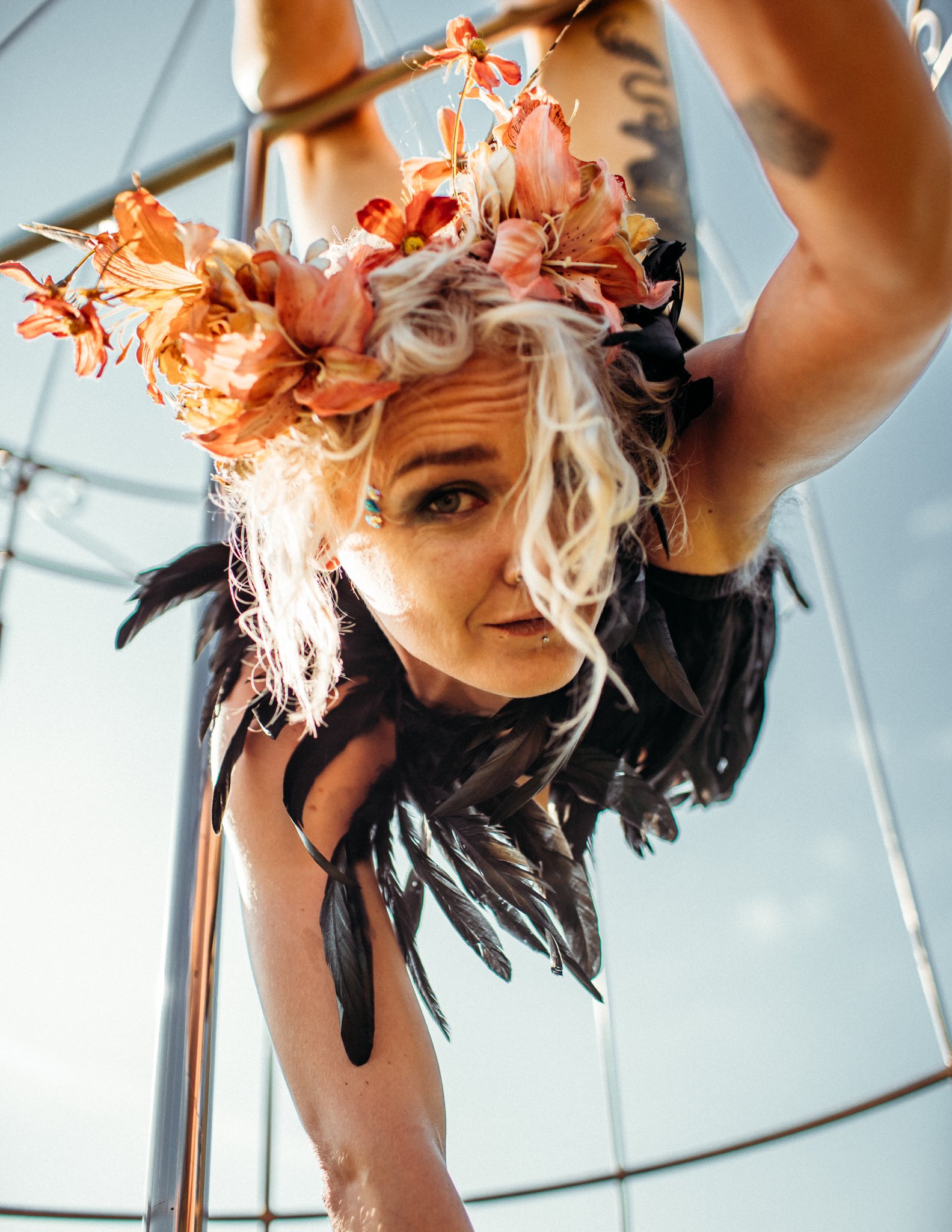 Girl hangs upside down in birdcage