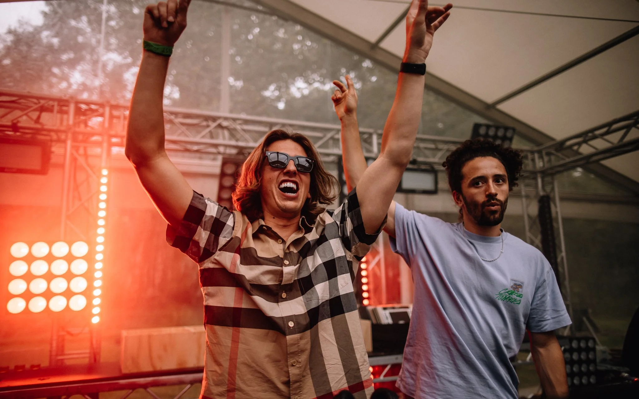  dJs with their hands in the air