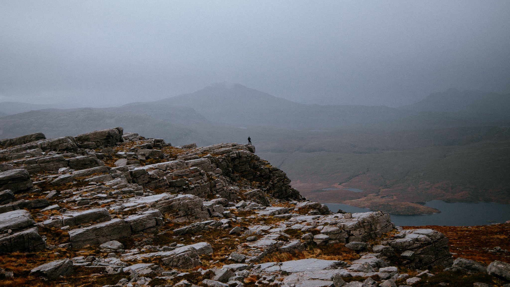 Man stands on mountain in Scotland