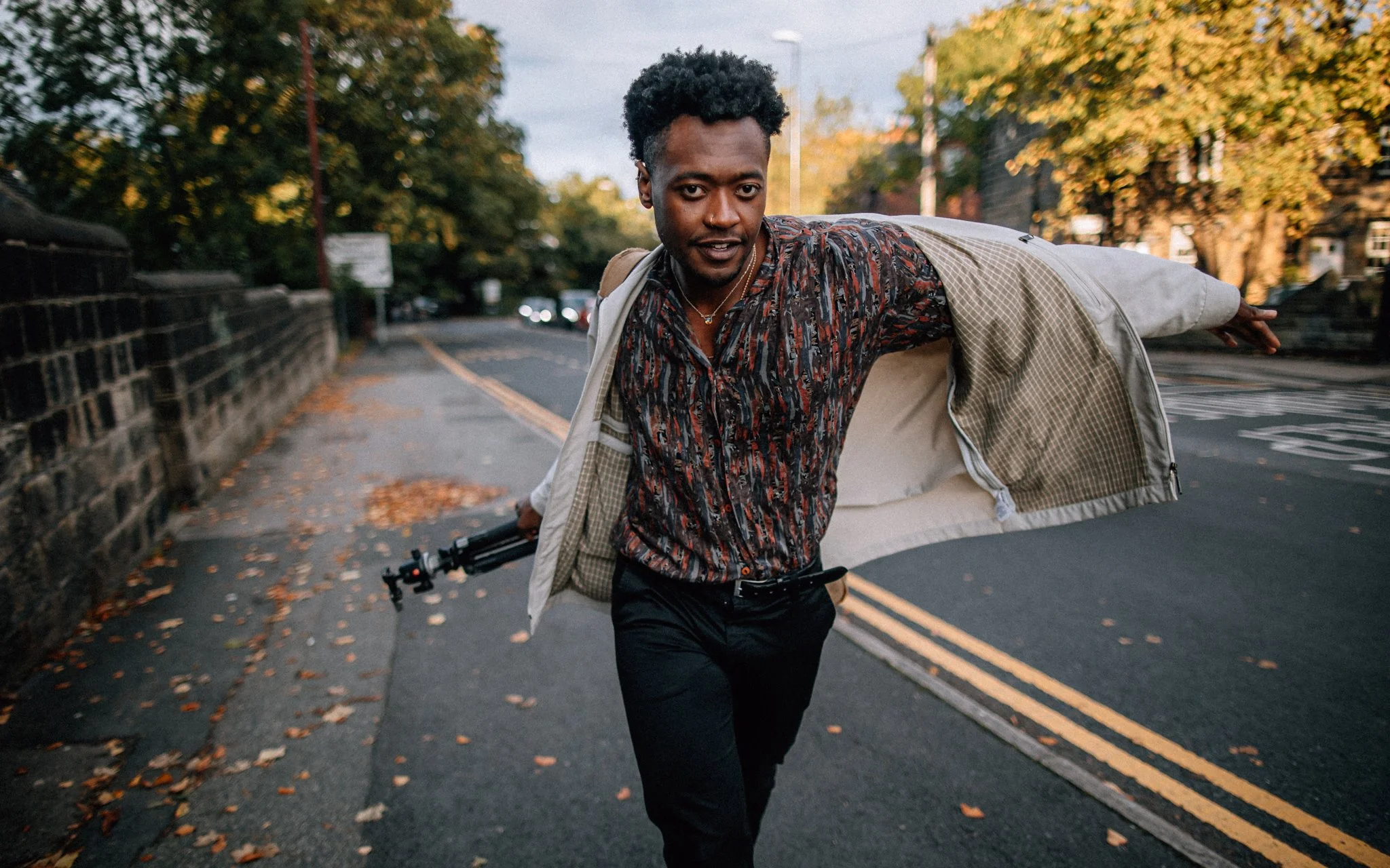  man, walks up, Street, putting on jacket fashion