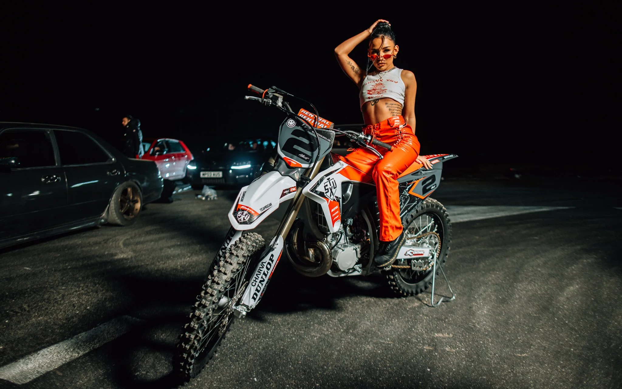  female model poses on dirt bike