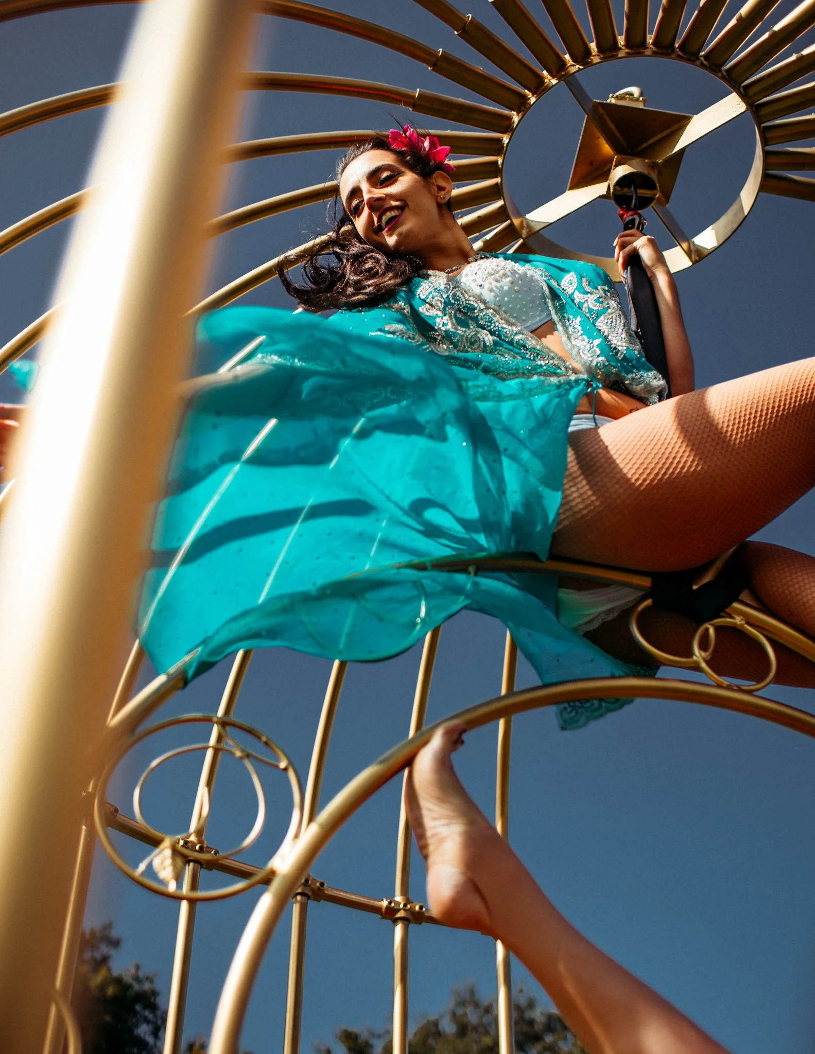 girl on aerial hoop in birdcage, blue flowing robes