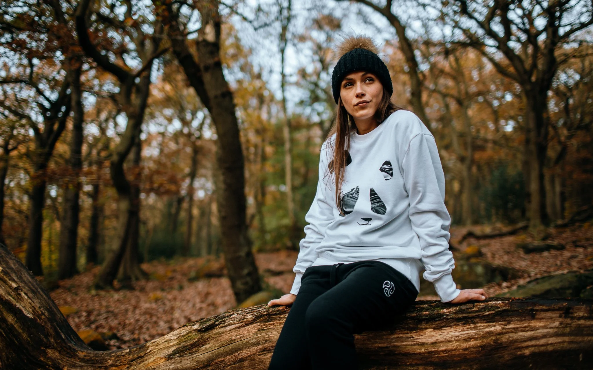  female model sit on log with panda head jumper by tomoto