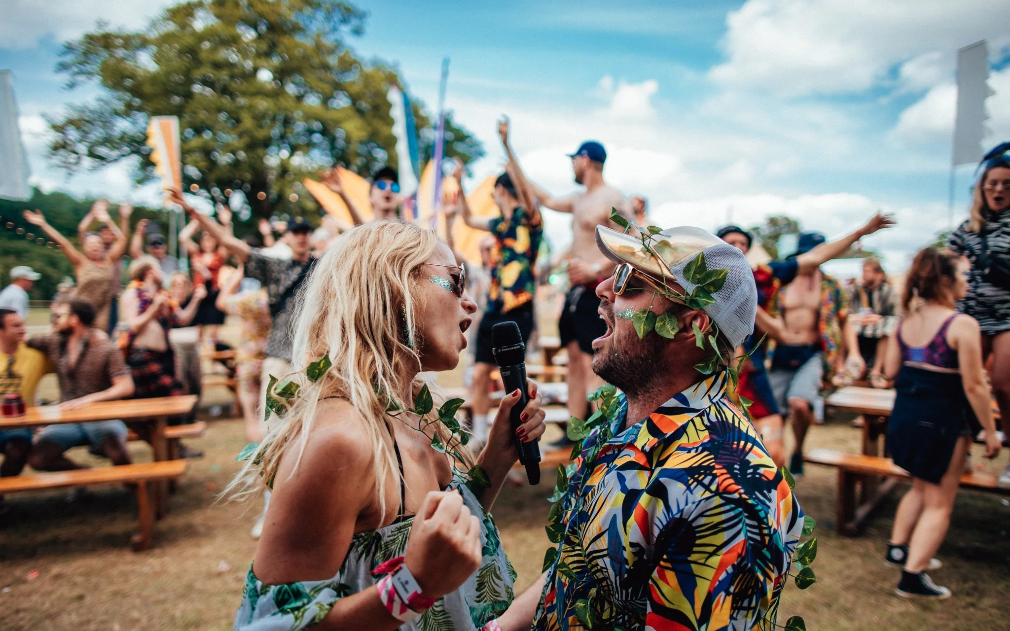  a man and woman seem to each other at a music festival