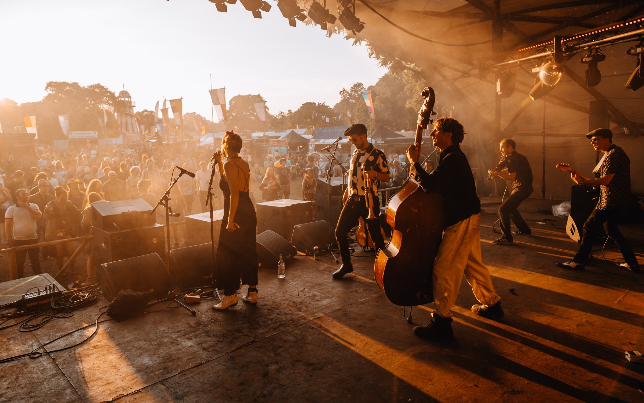 A band play in the sunset at a music festival in Scotland