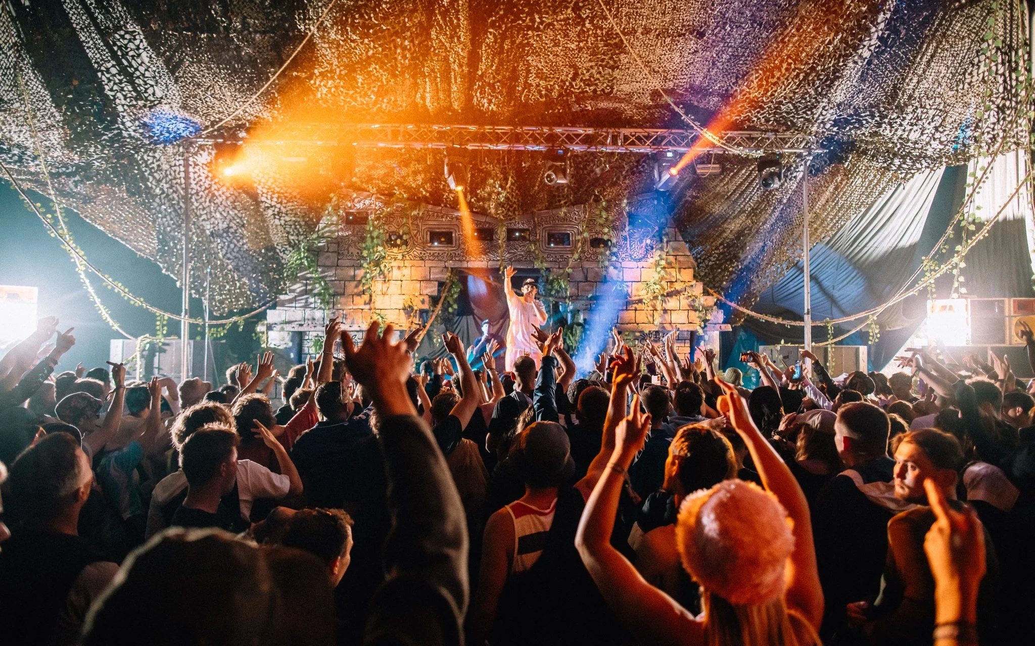 A crowd of terror, music festival dancers to a DJ