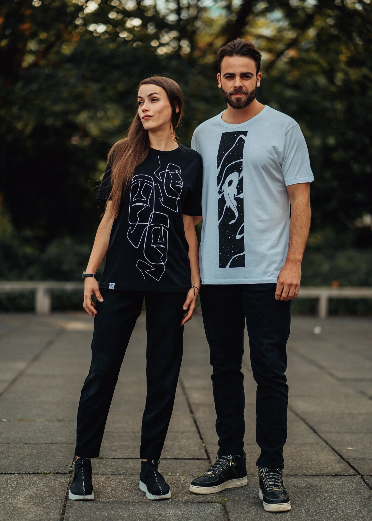 female and male model pose together