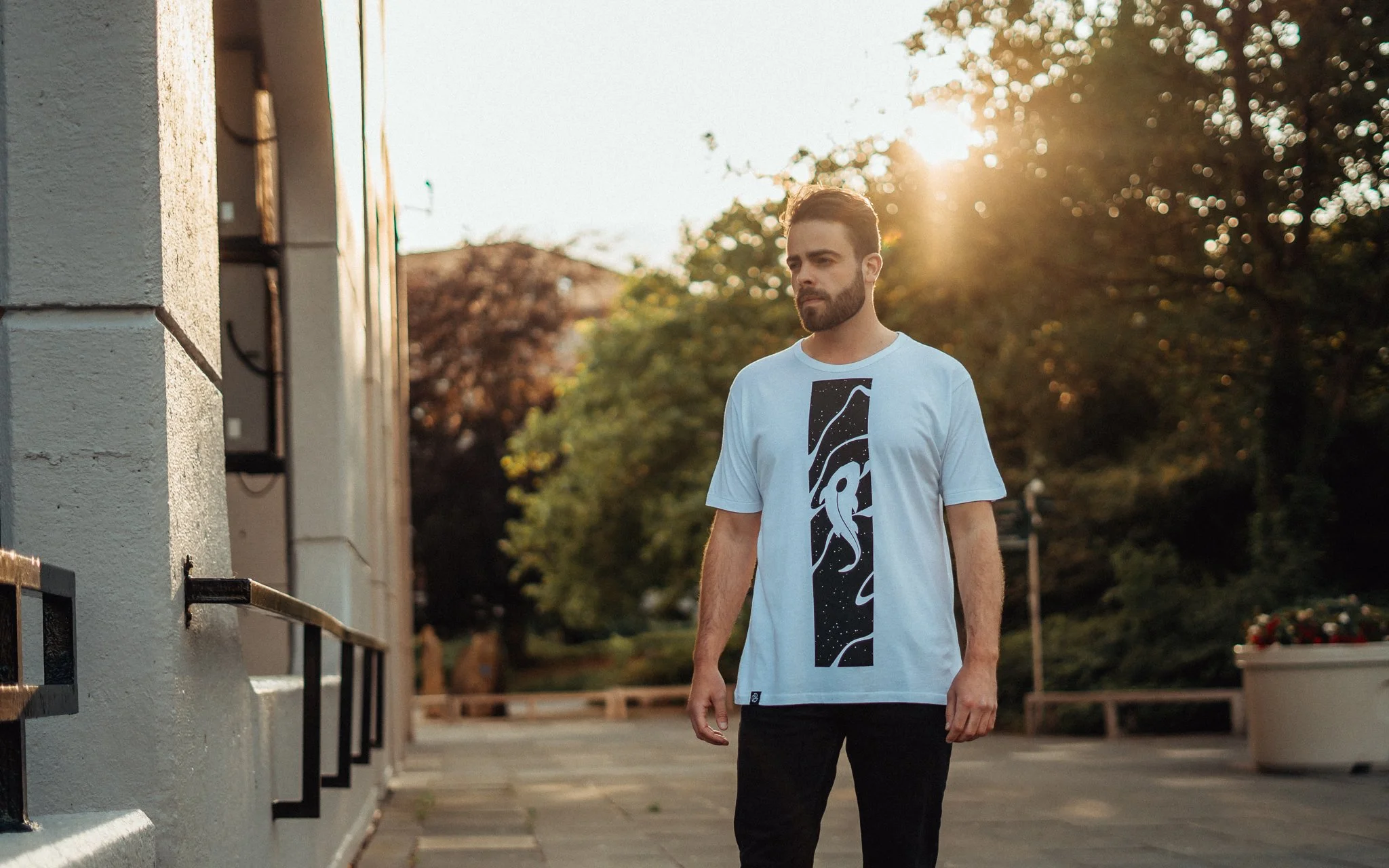 Man poses in a T-shirt in Sunset