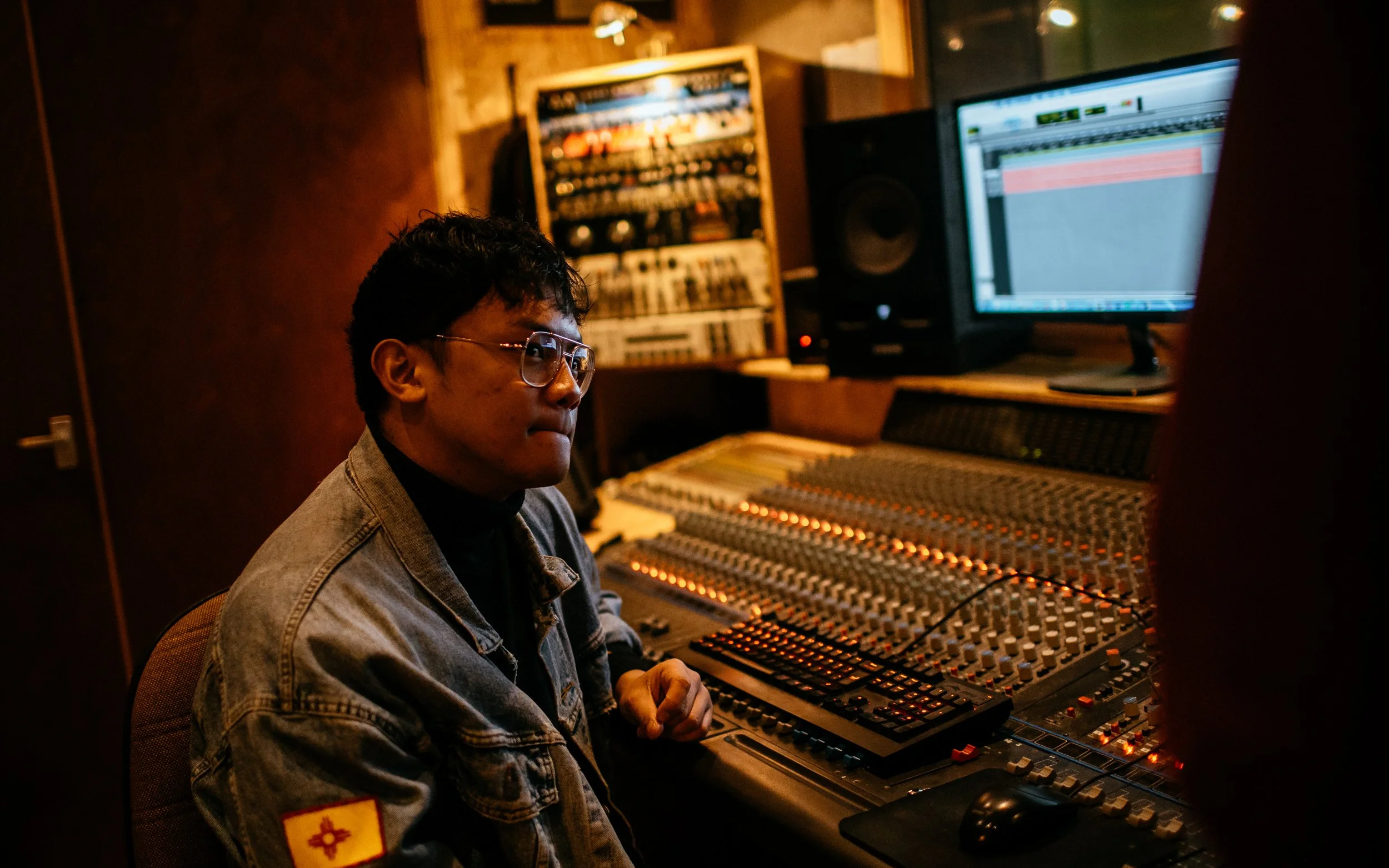  music studio staff in front of mixing desk