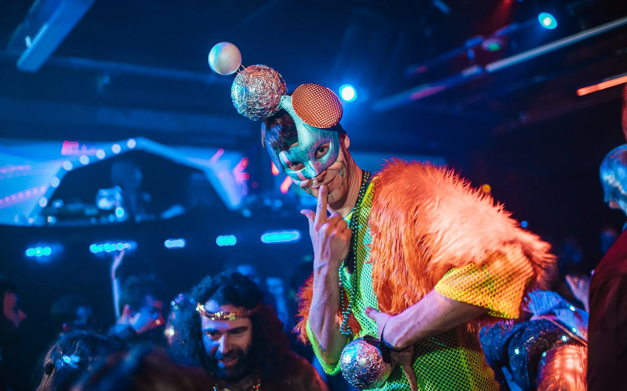 man in nightclub with an interesting hat