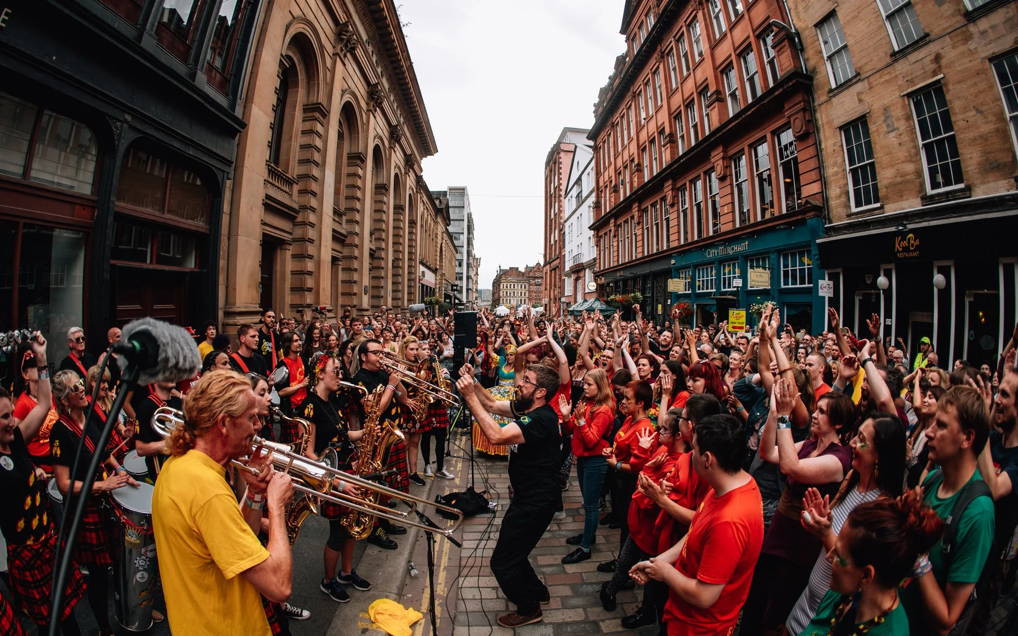 A huge crowd dancers to a street band in Glasgow city centre