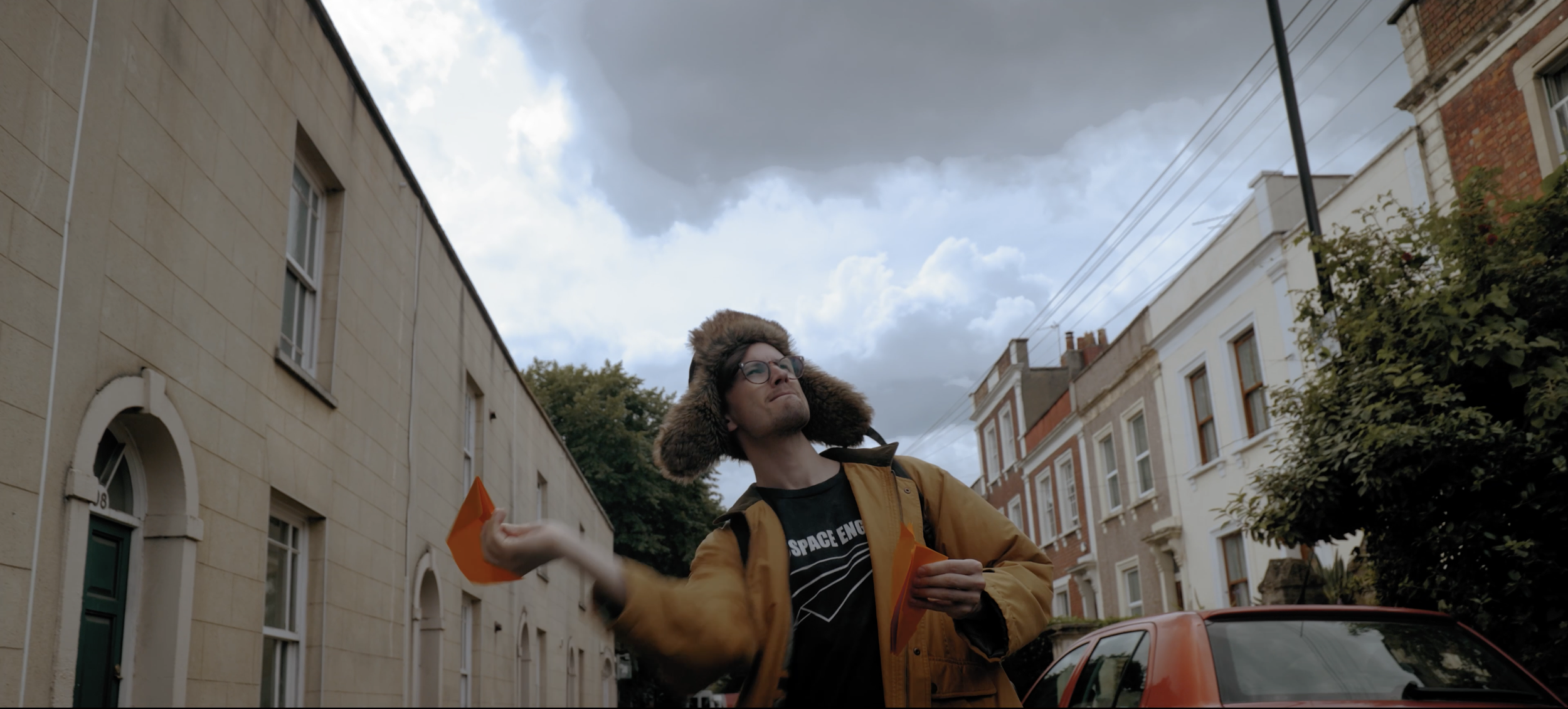 Twogood Music video Garry fingerloaf prepares to throw his first paper aeroplane