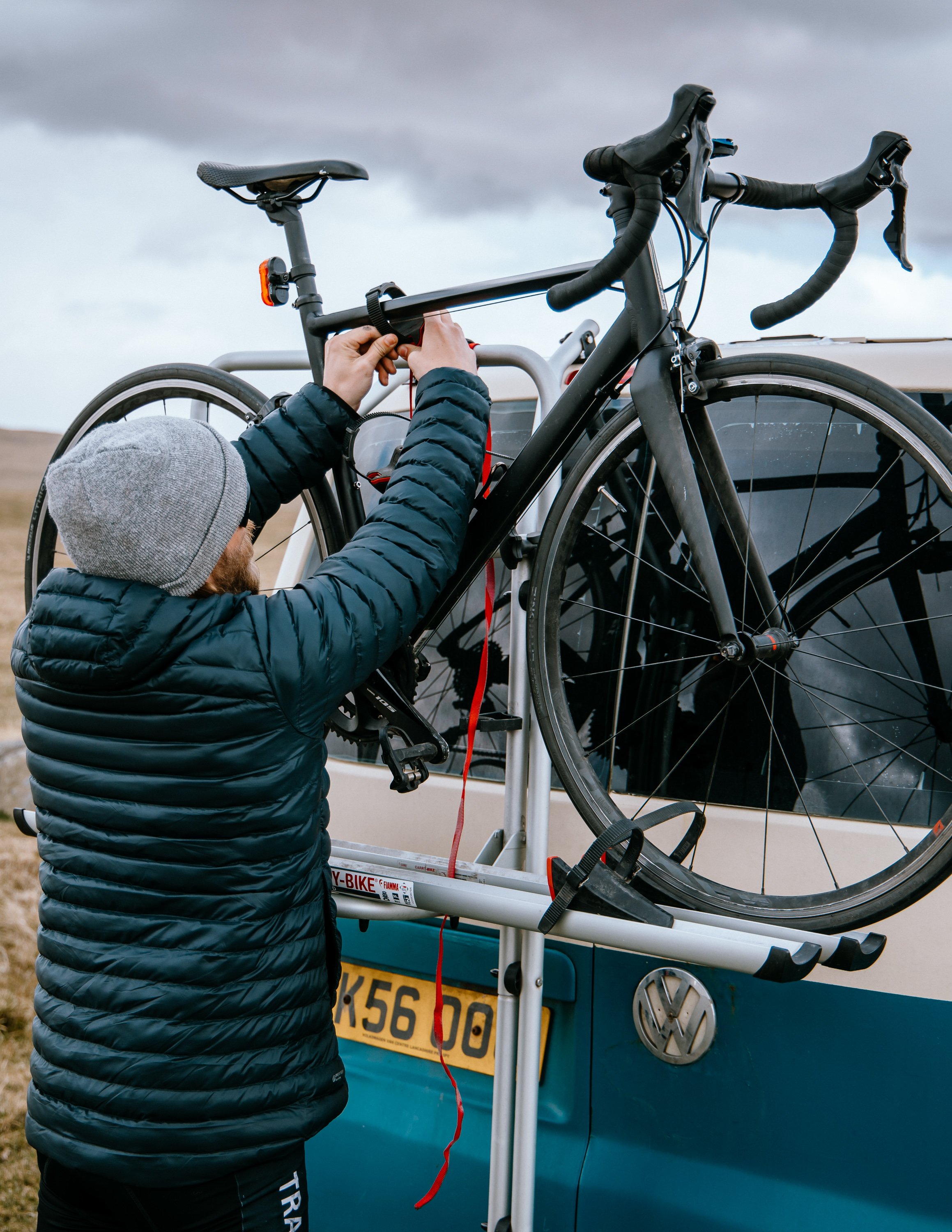  man takes bike off back of the van