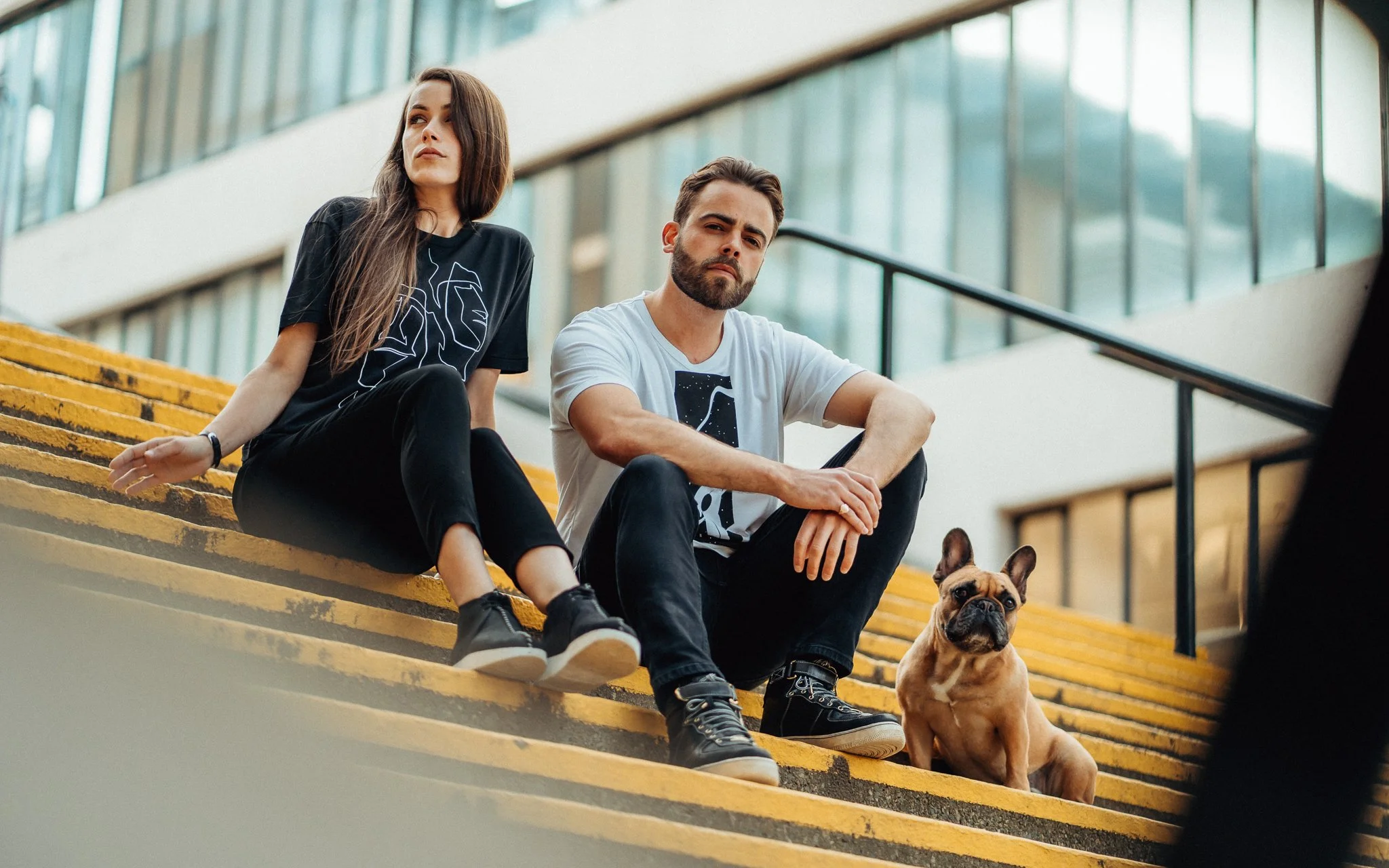  girl, man, dog sit on steps yellow