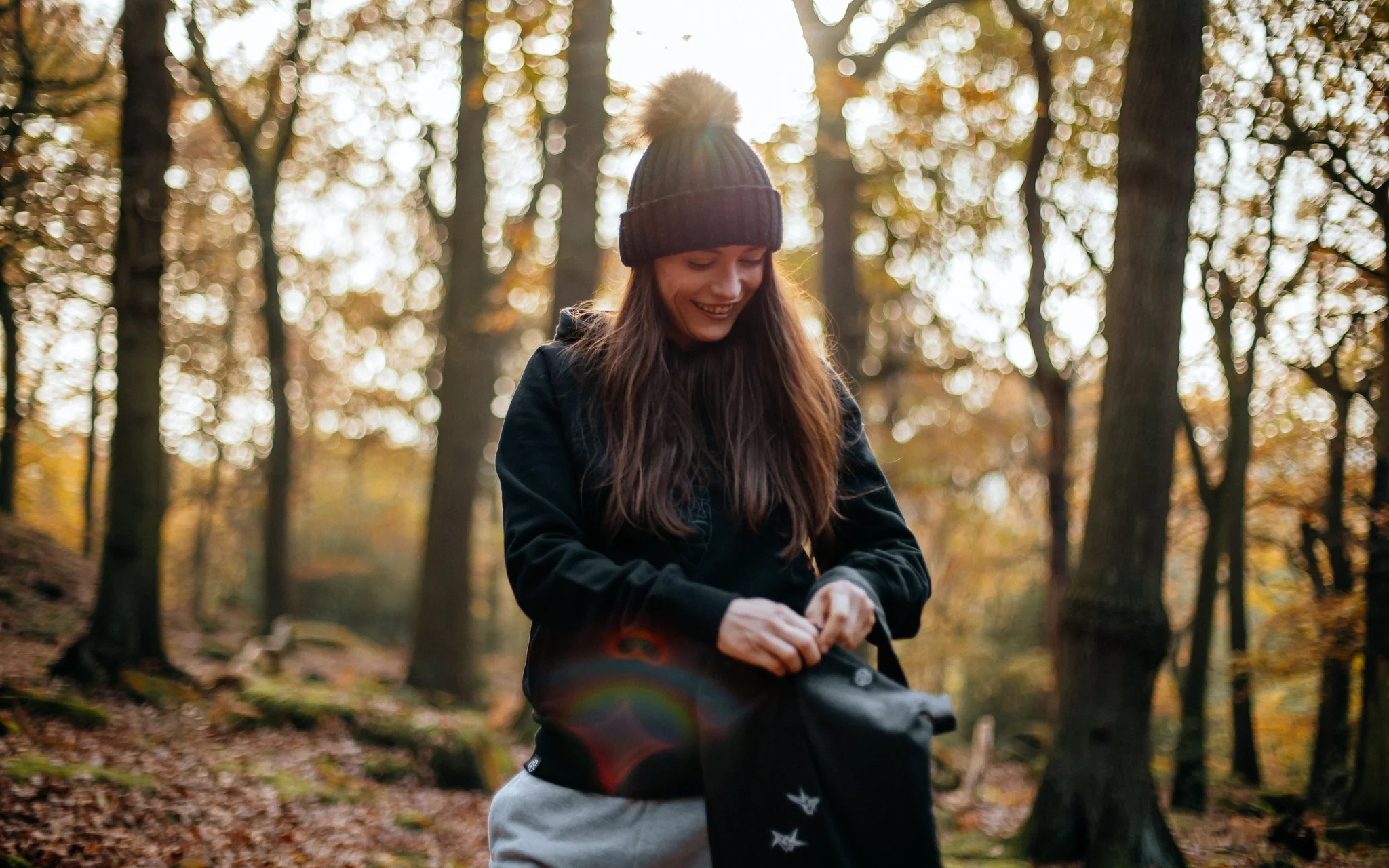  model poses in woods with bag by tomoto
