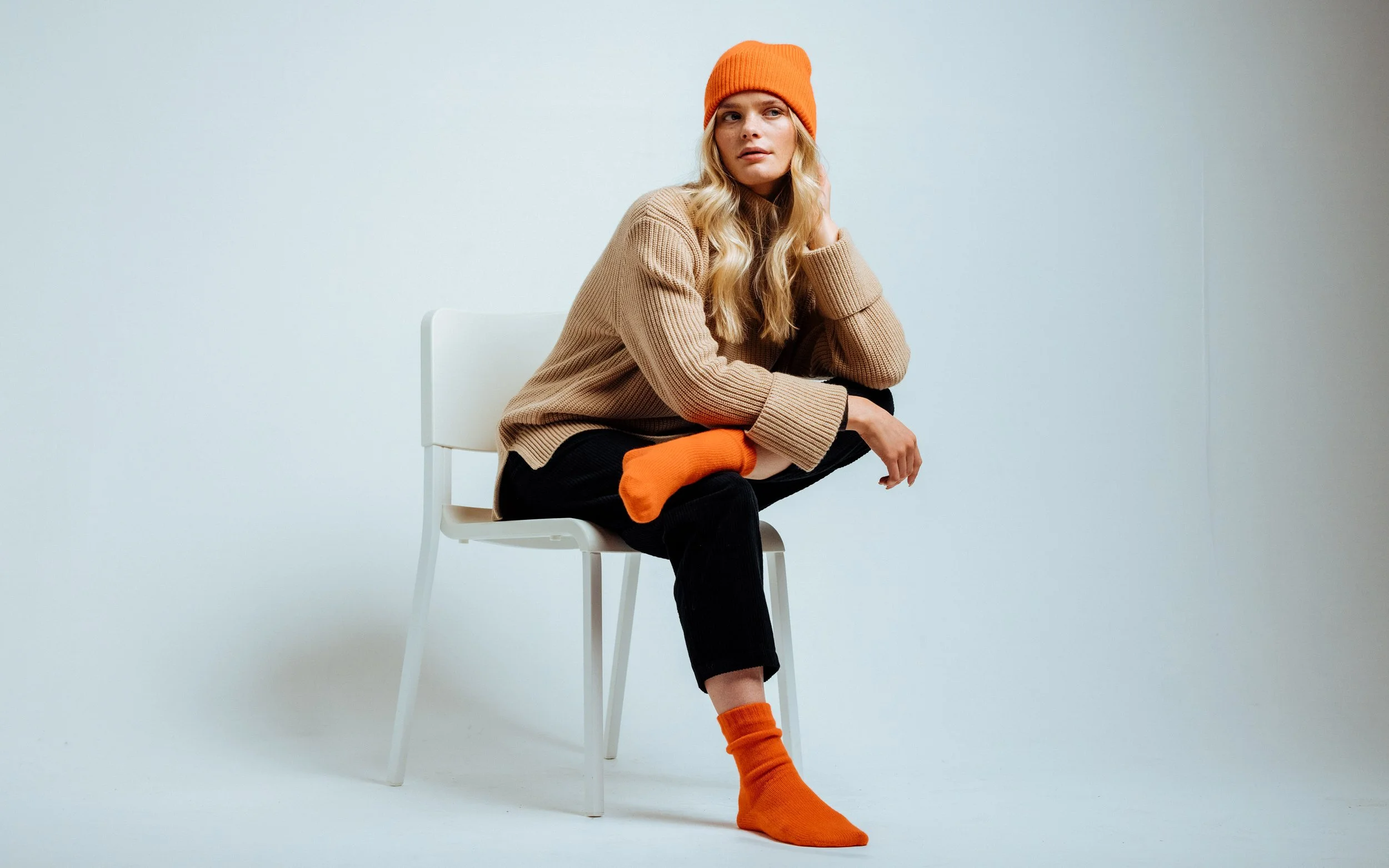  poses in orange cashmere, hat and socks