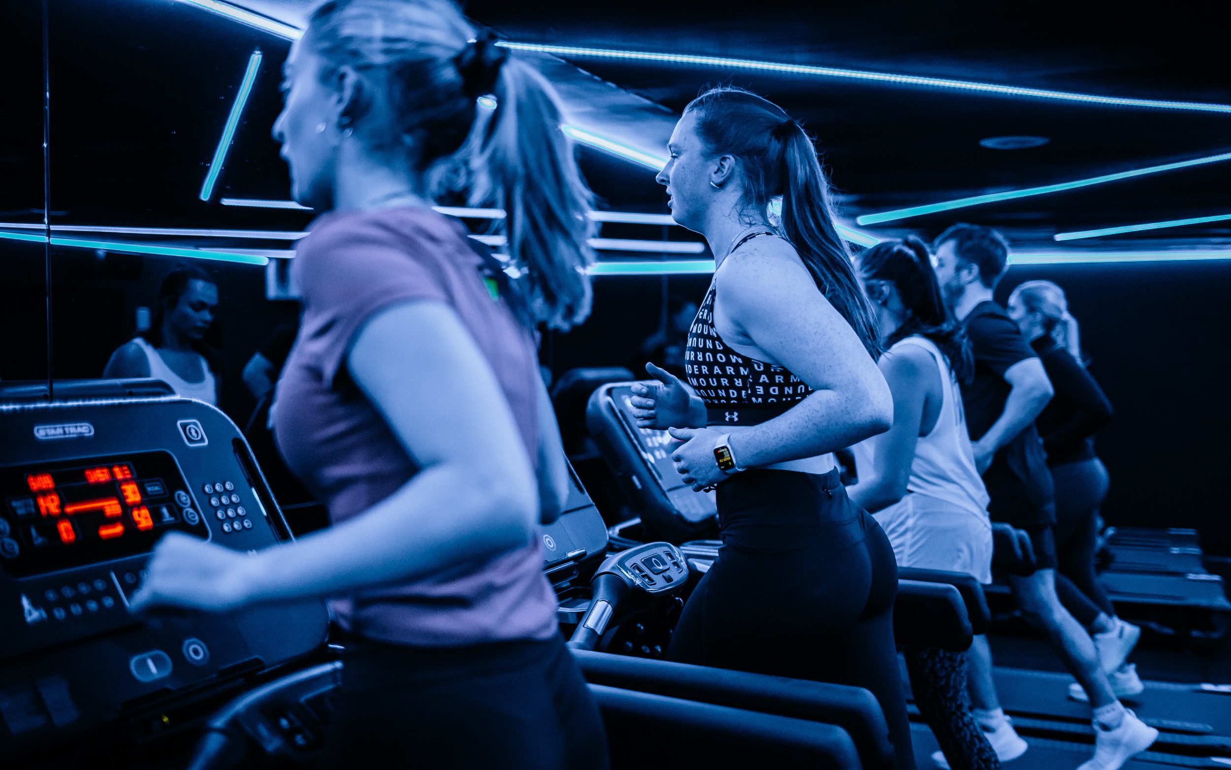  girls running on the treadmill with blue lights