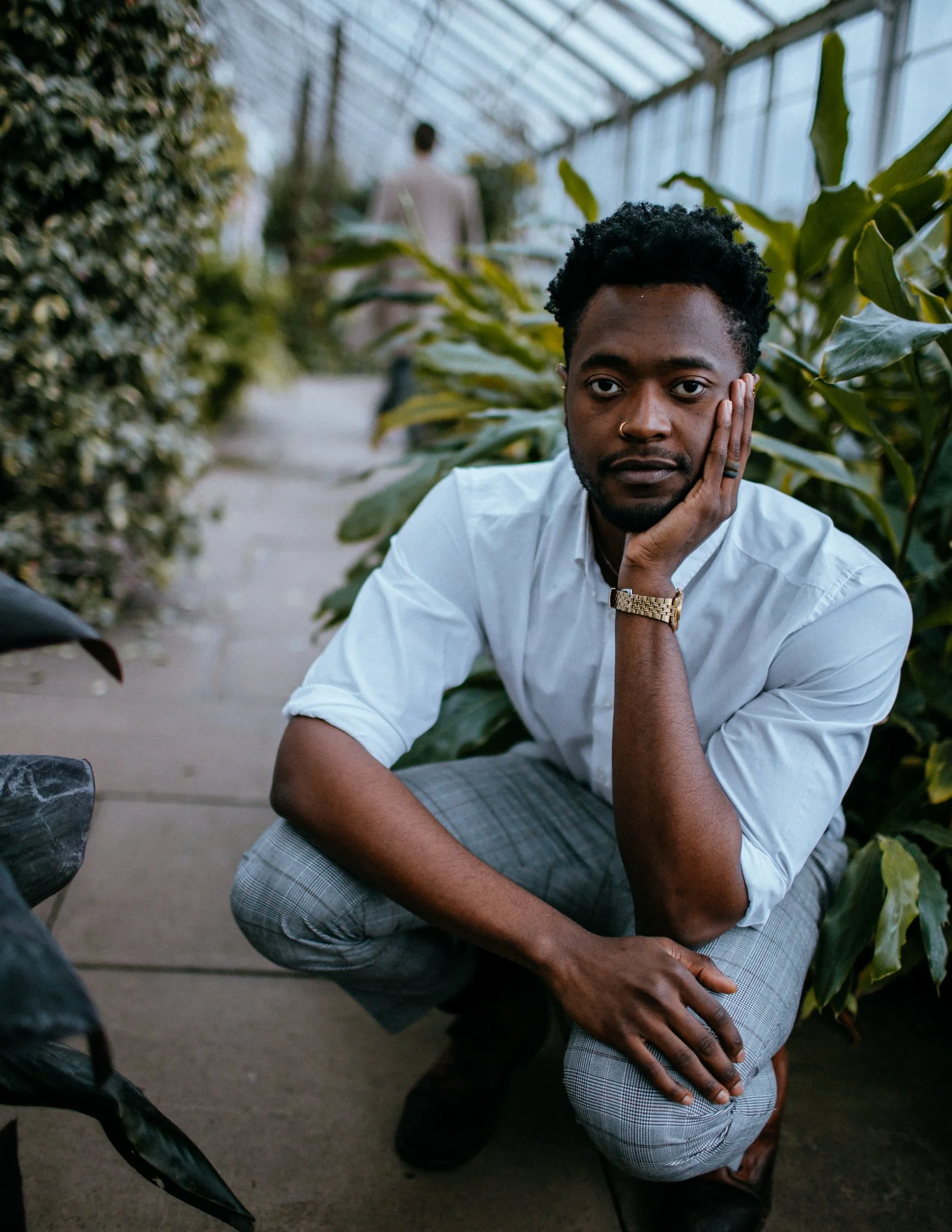 Portrait of man, squatting in greenhouse
