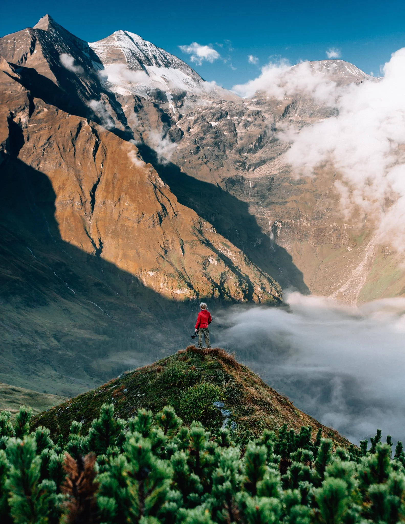  man, stands on a mountain in the Alps