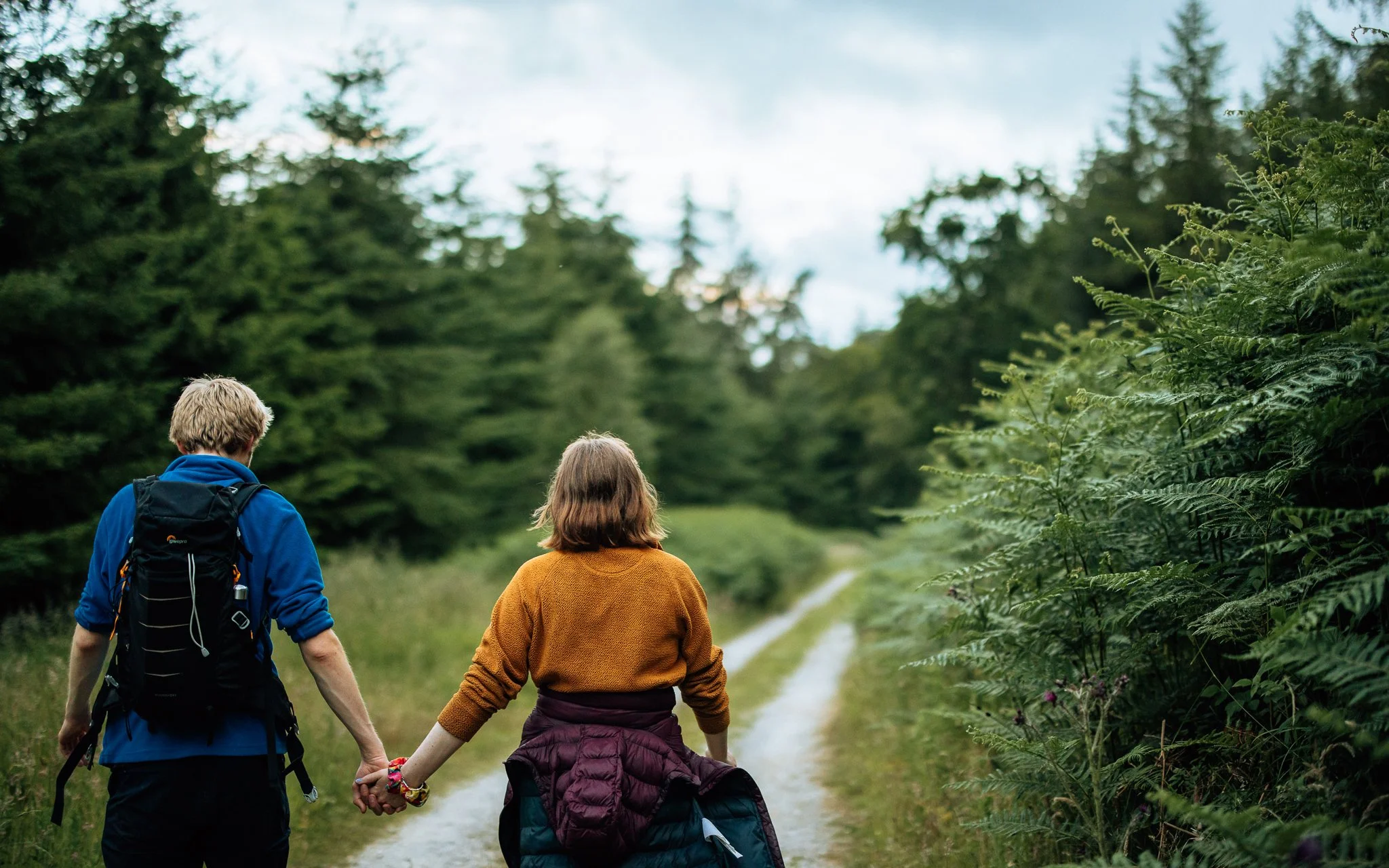 man and woman hike along track