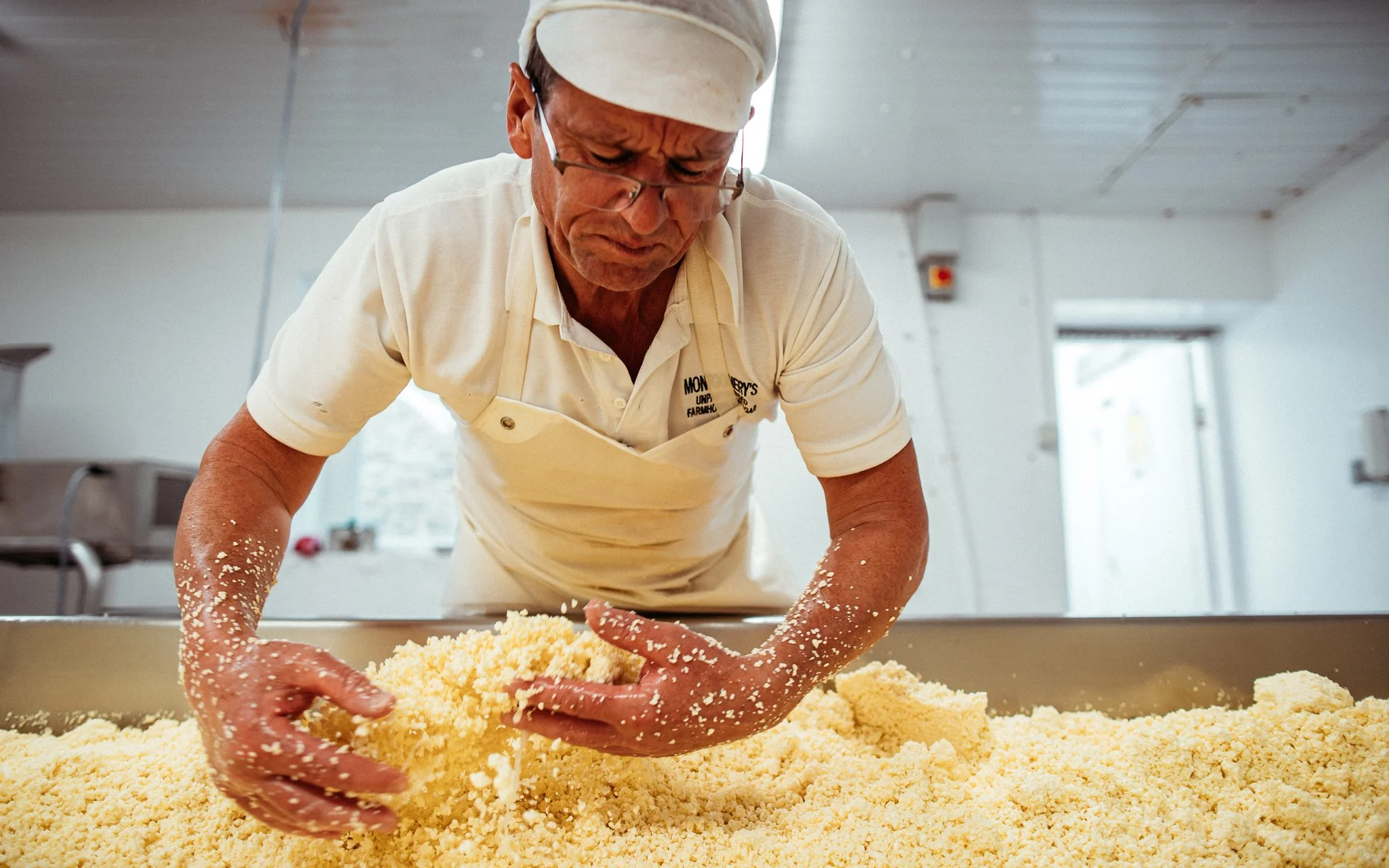  a man makes cheddar cheese