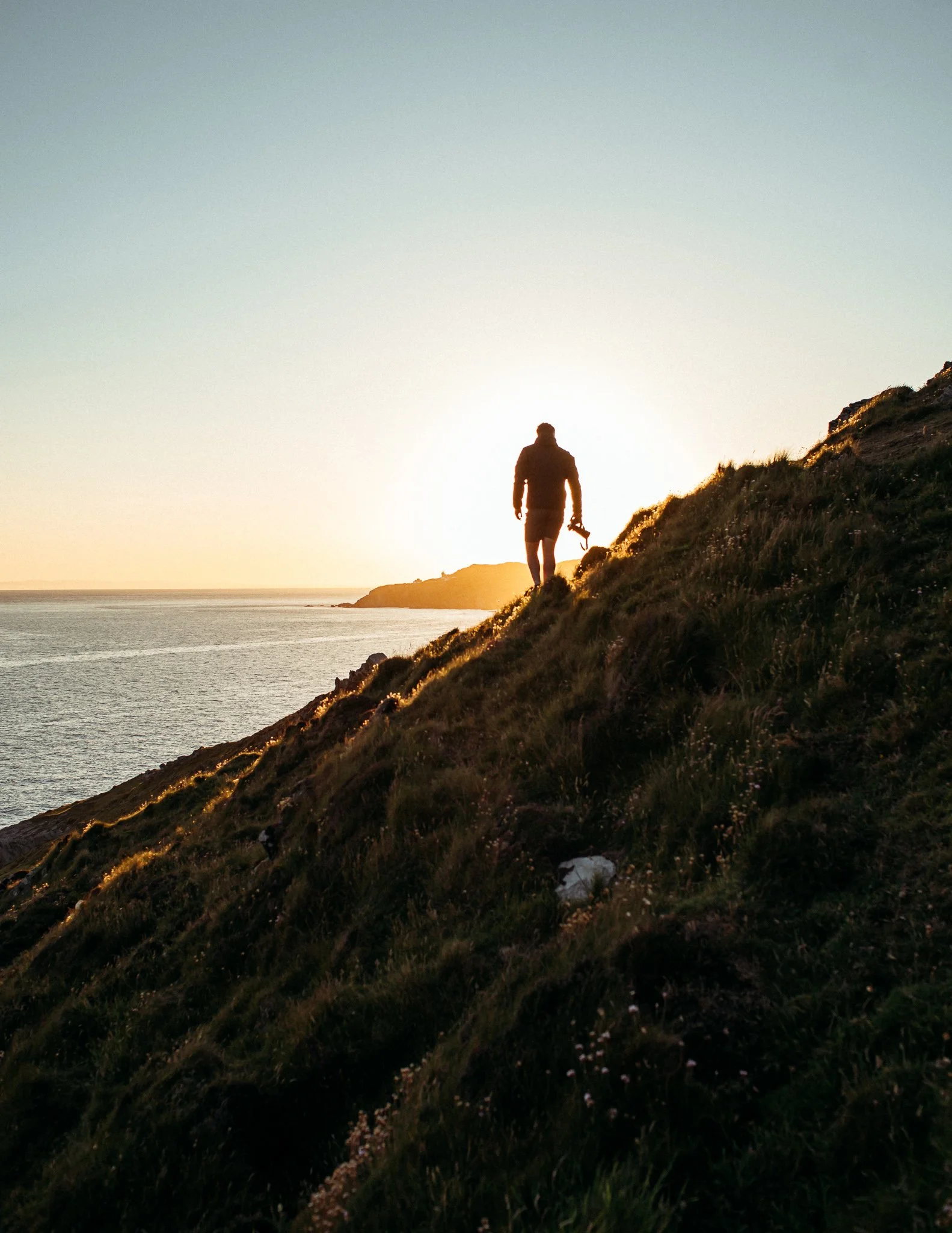  photographer walks into the sunrise, Devon