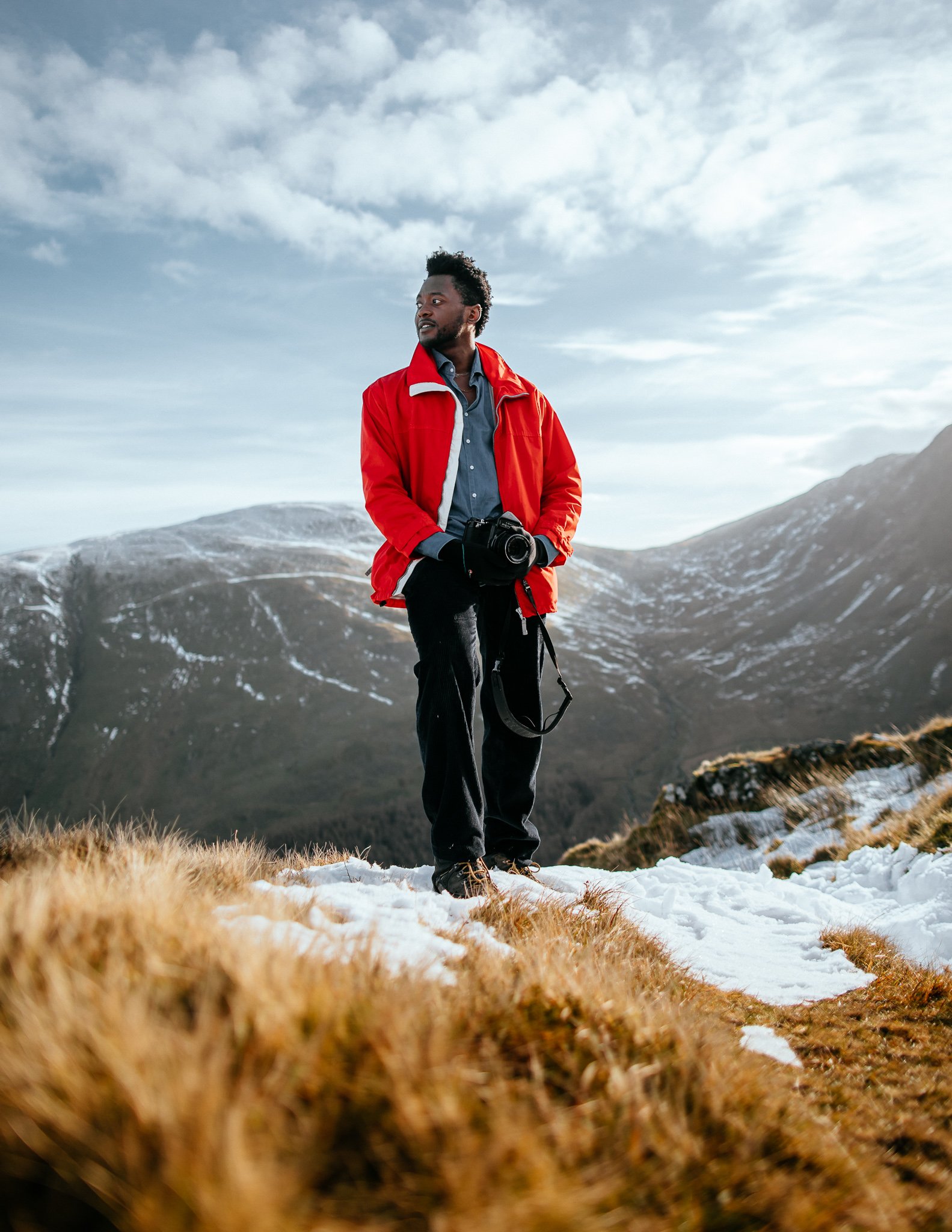 Portrait of man with camera walking in Lake District