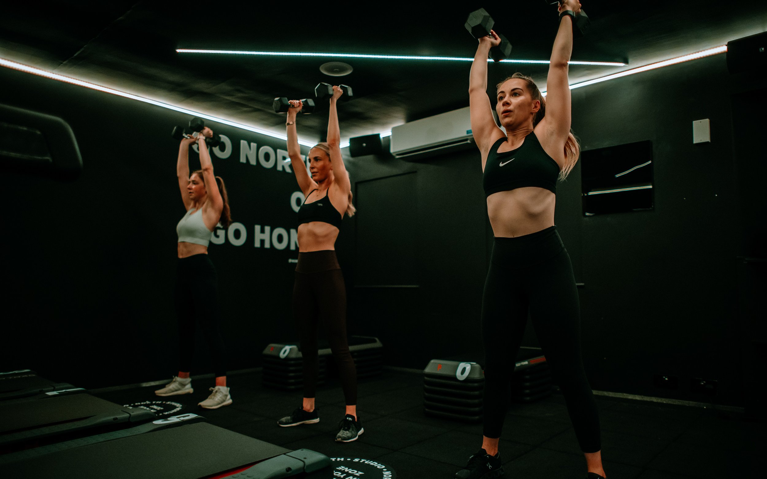 Women lift weights during workout at North Studio Leeds