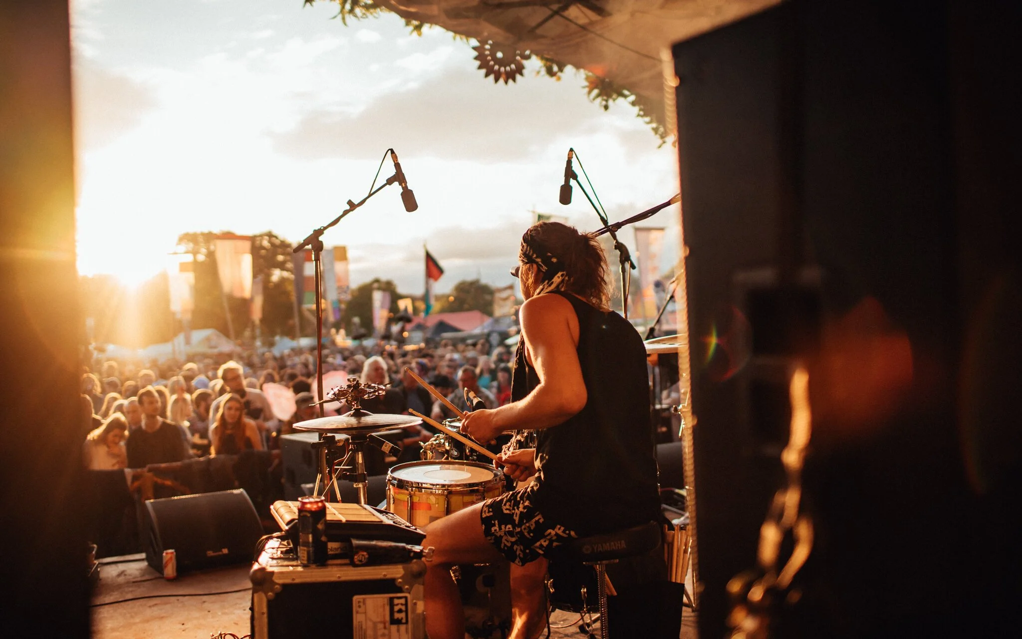  a drummer plays in the sunset at a music festival Scotland