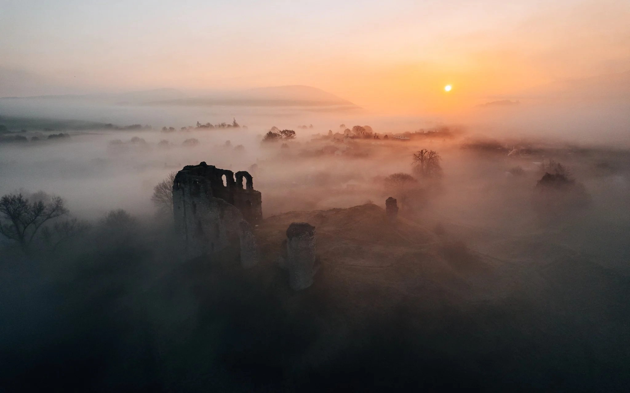 Sunrise over clun castle on a misty morning, Shropshire