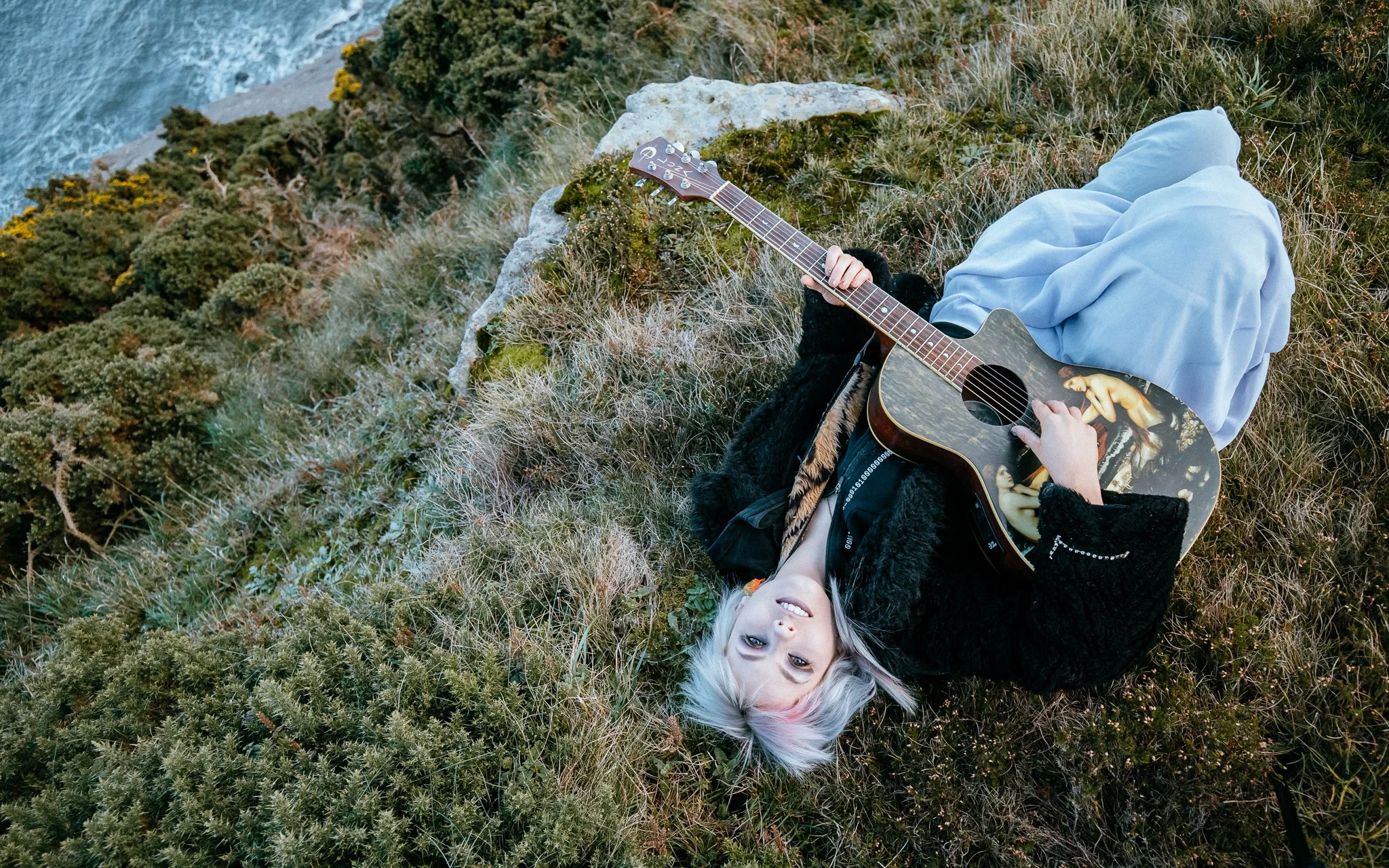 Portrait of Girl playing guitar by the sea