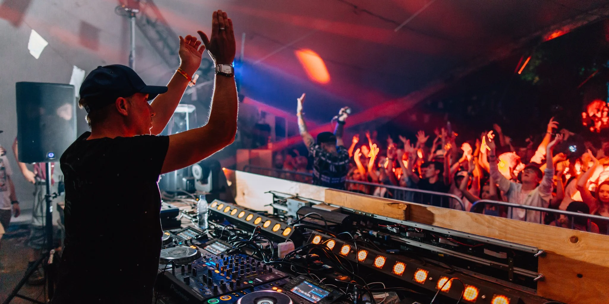  a DJ waved his hand whilst playing at the Kelburn garden party in Scotland