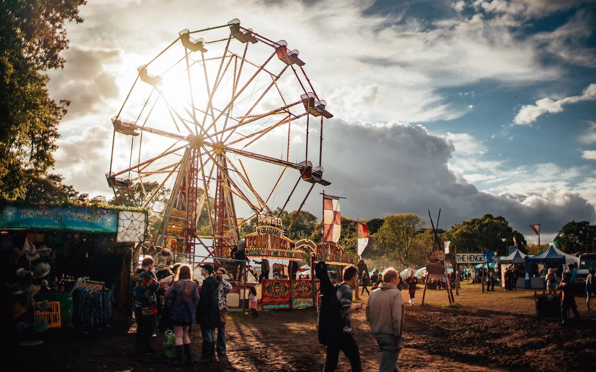  a large fairground ride in the sunset at a UK music festival