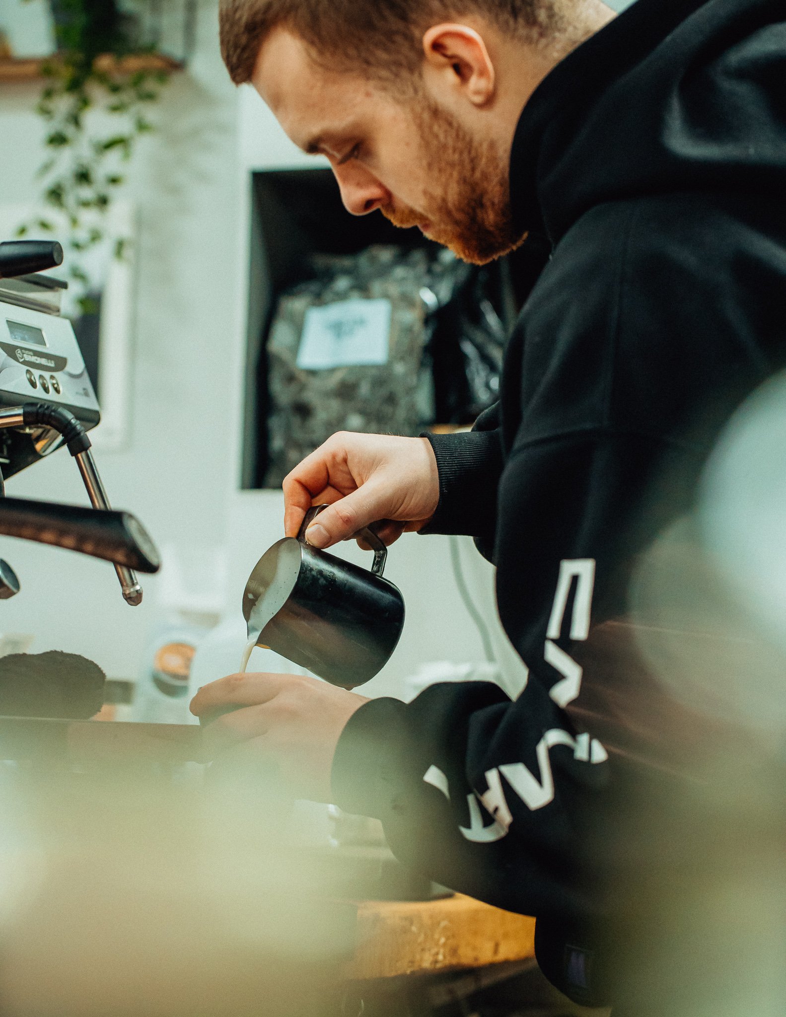 Man pours a latte
