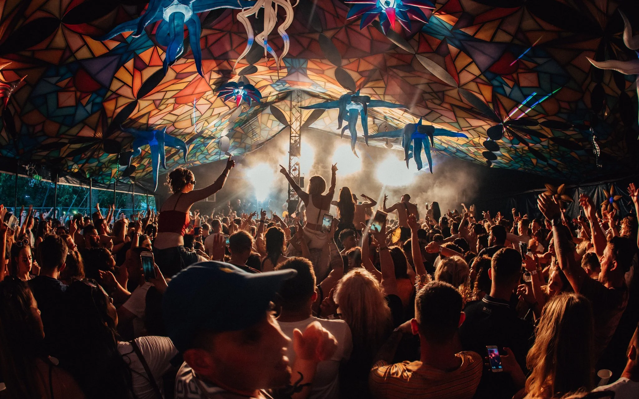 a crowd of people dancing at the music festival in Leeds