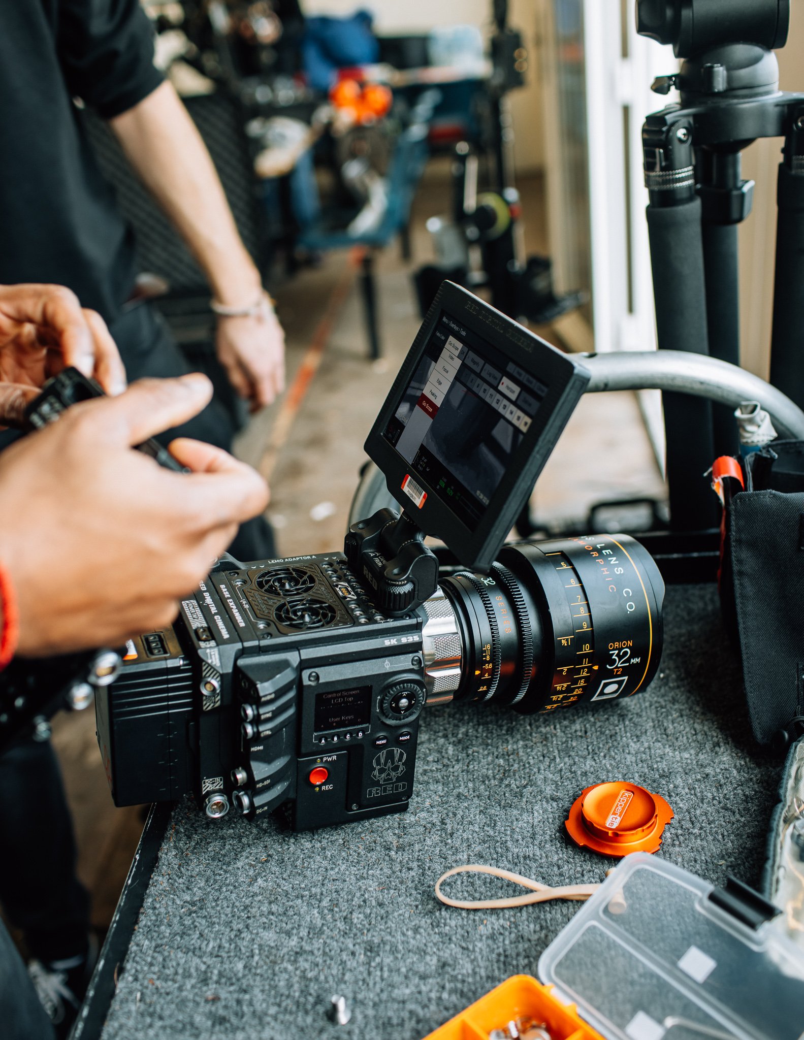  a red cinema camera being set up with cook lenses
