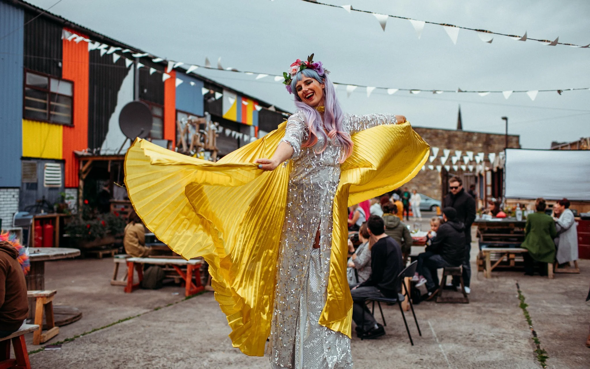 A performer in glittery outfit at a music festival