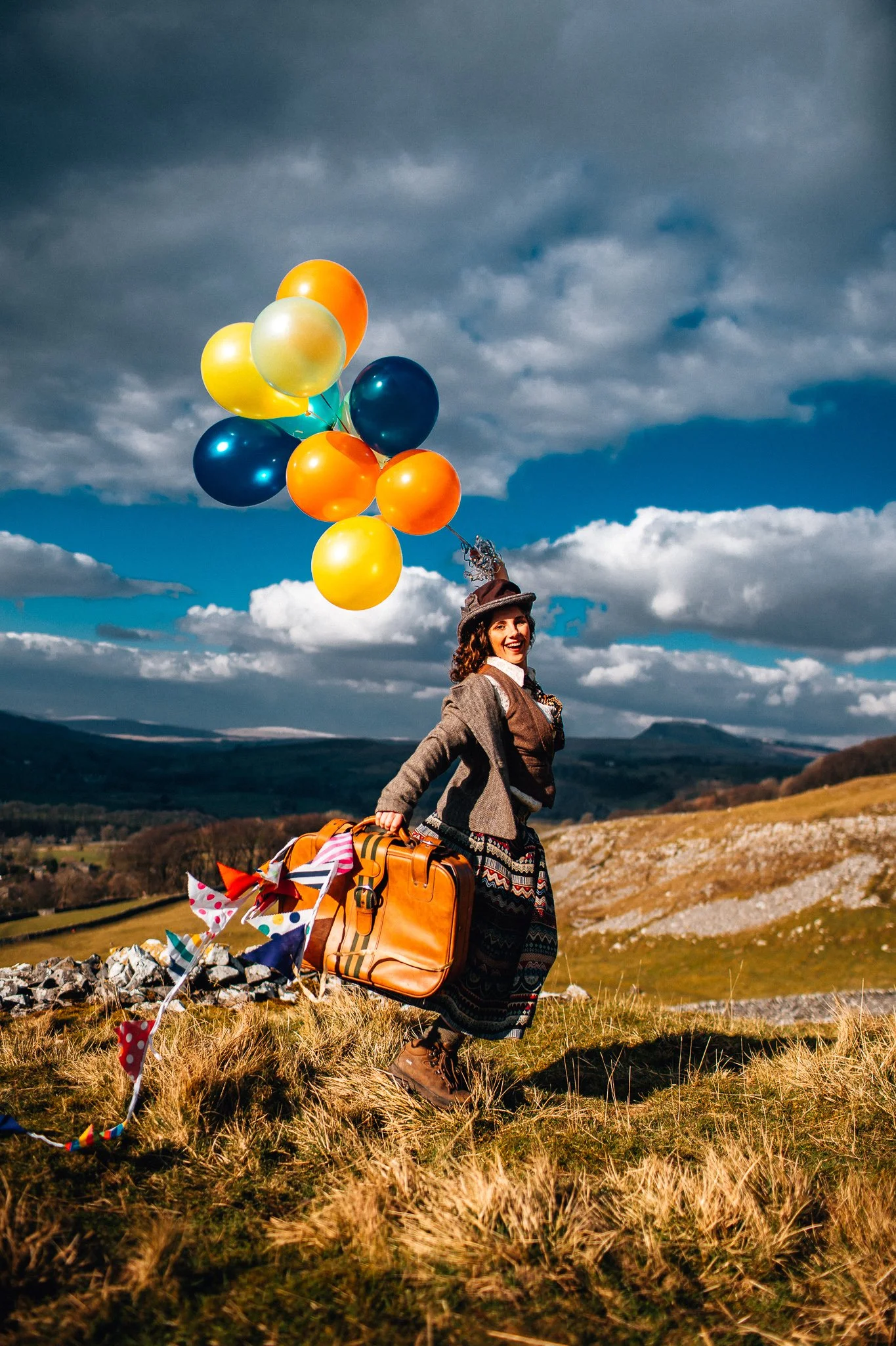 Lady with suitcase and lots of balloons
