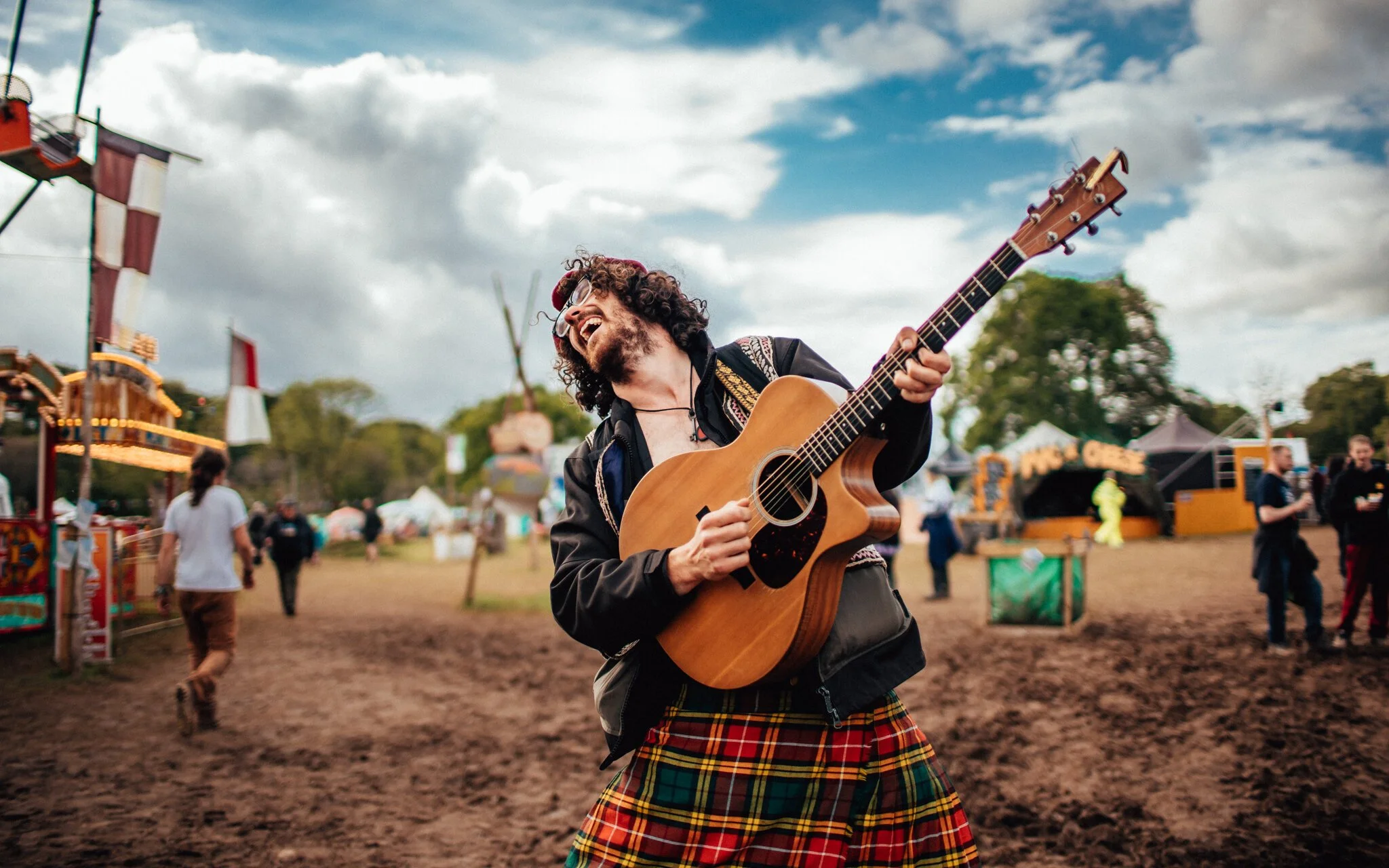  man plays the guitar at a music festival