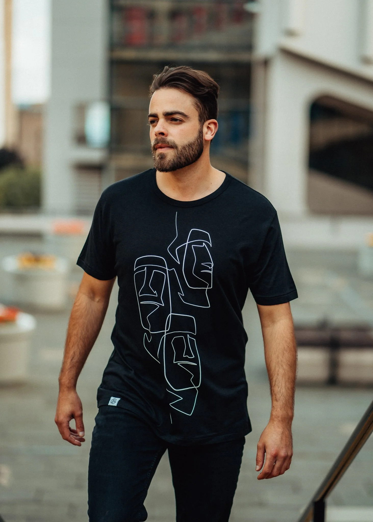 Male model walks up steps in Easter island, head T-shirt by tomoto