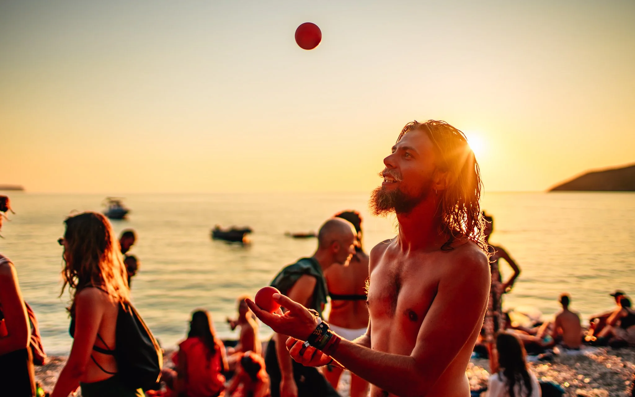  a man juggles on the beach in Croatia