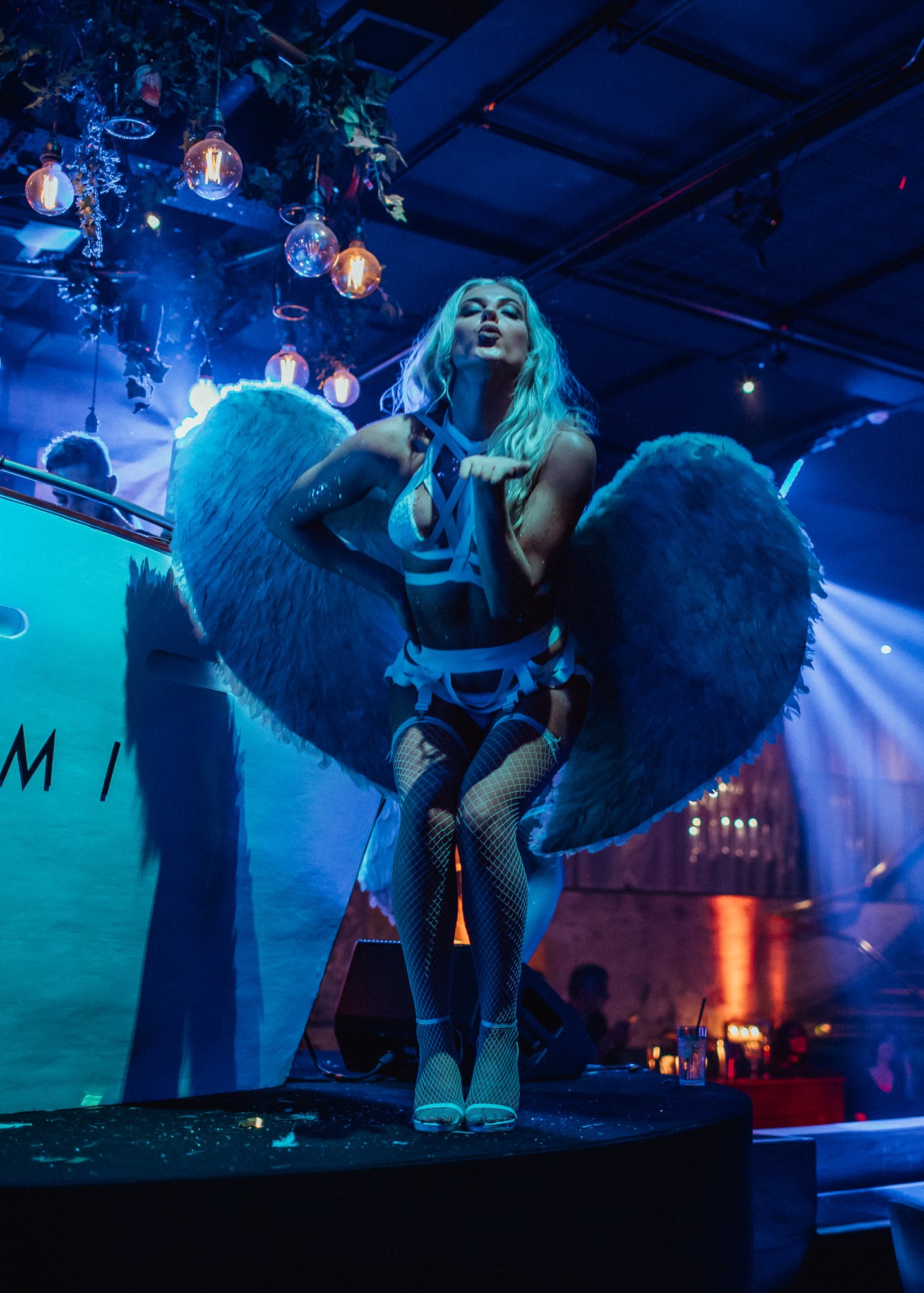  girl in angel costume, blows kiss