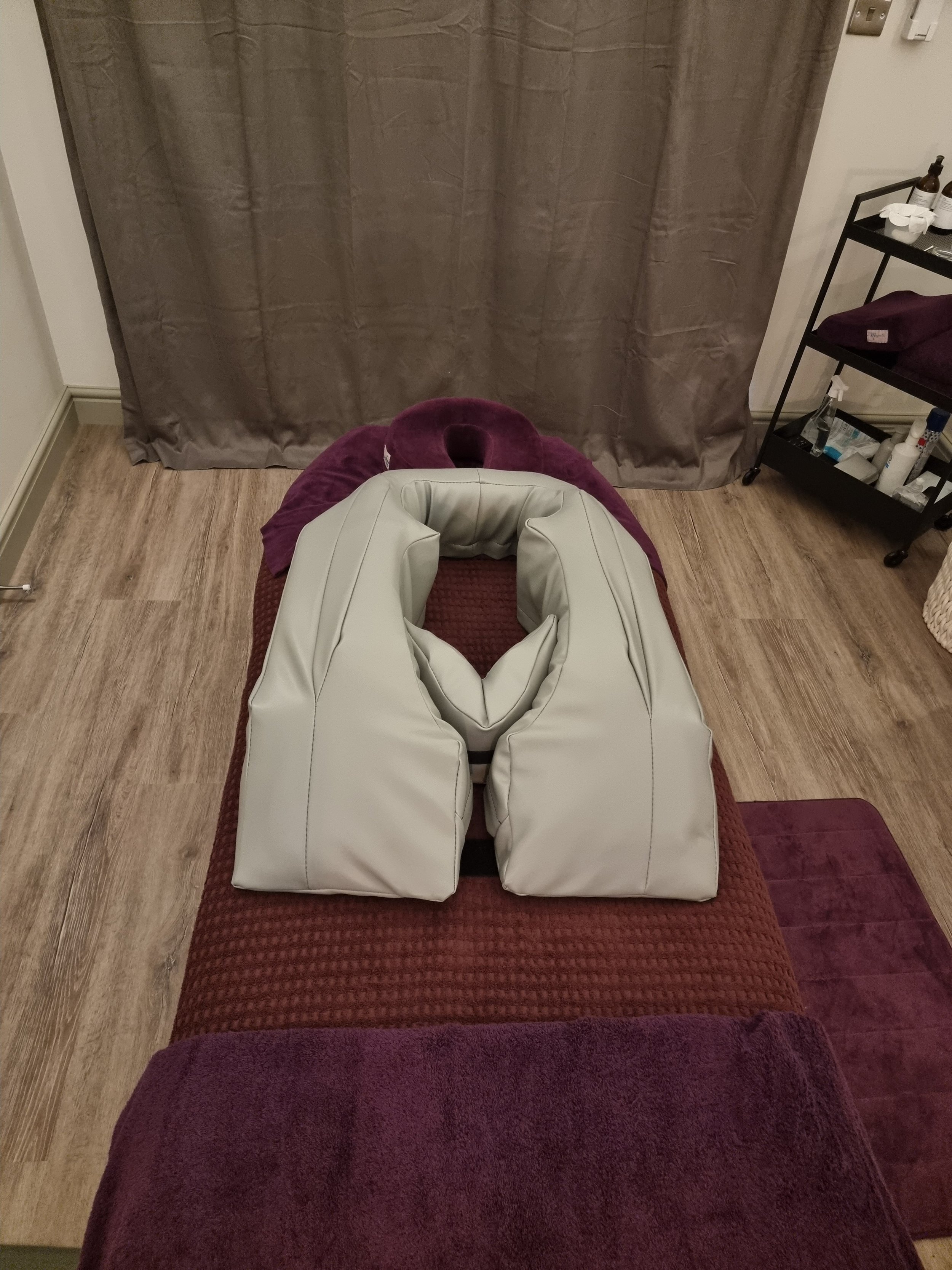 Treatment bed showing specialised pillow for Pregnancy massage at Idyllic wellbeing Leicestershire.jpg