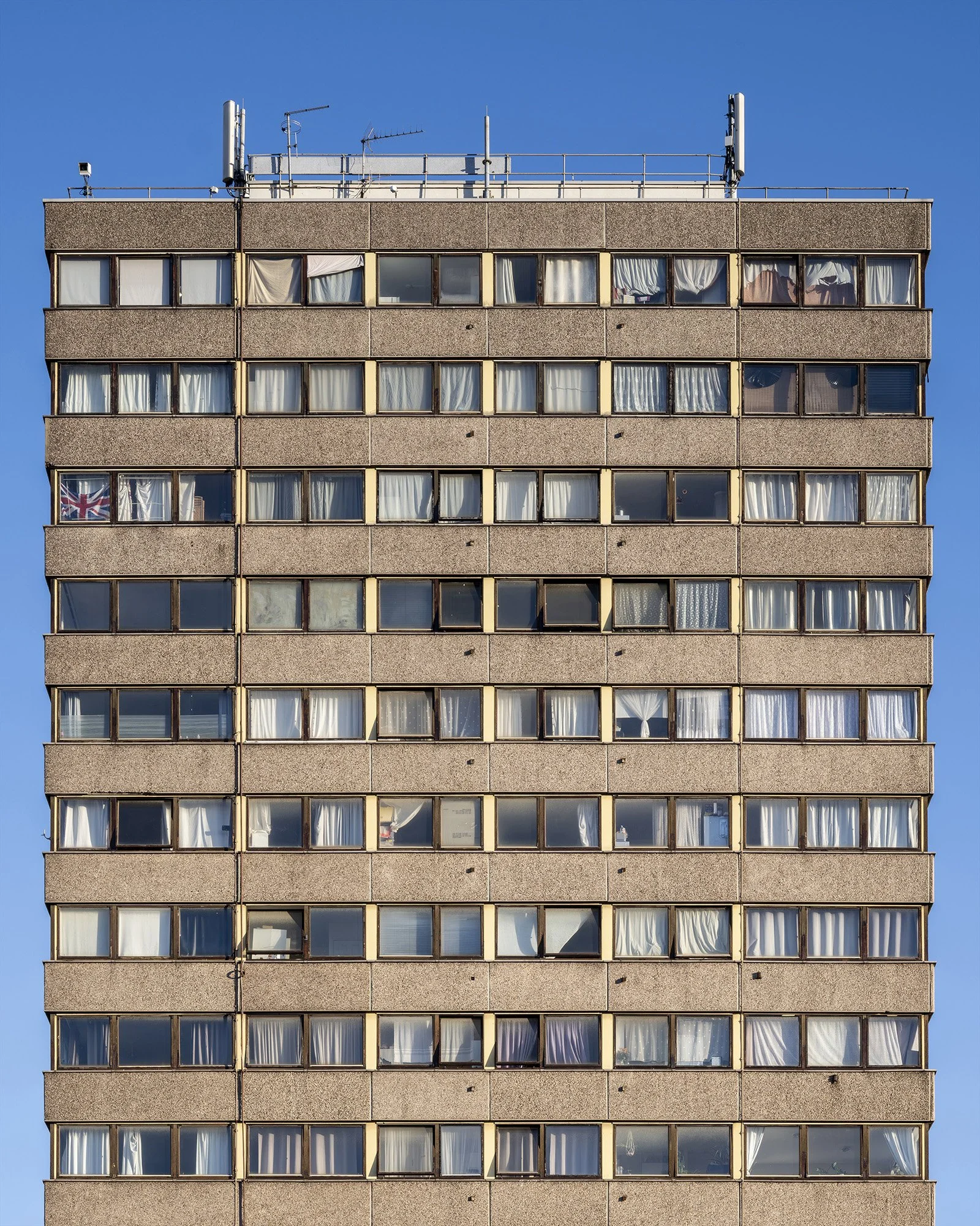 tower block windows blue sky uk