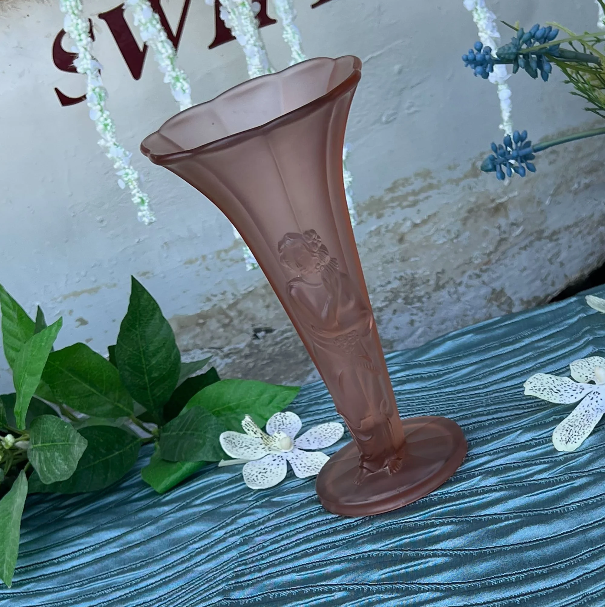 Pink glass vase with figurine on stem