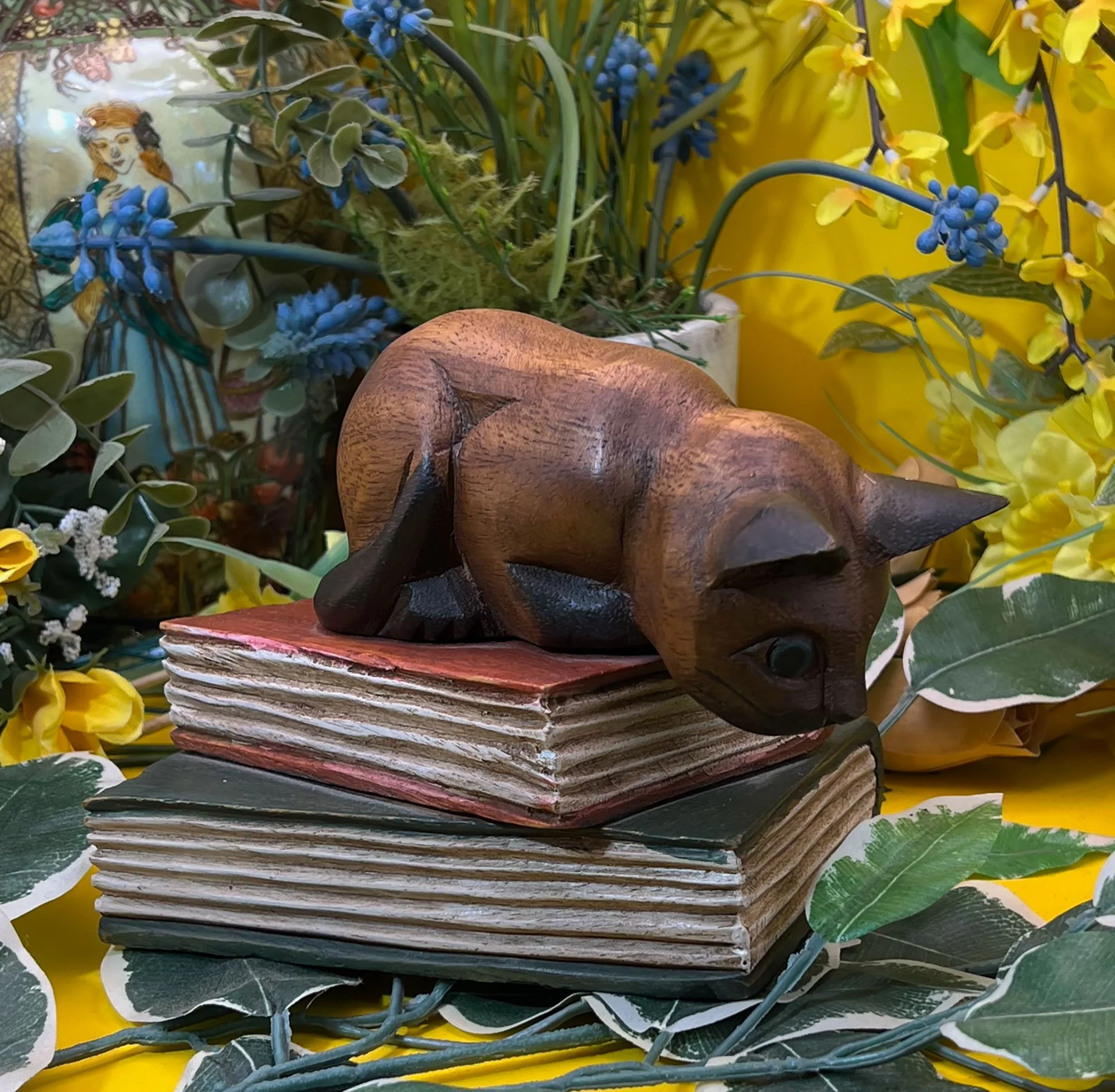 Wood cat on books